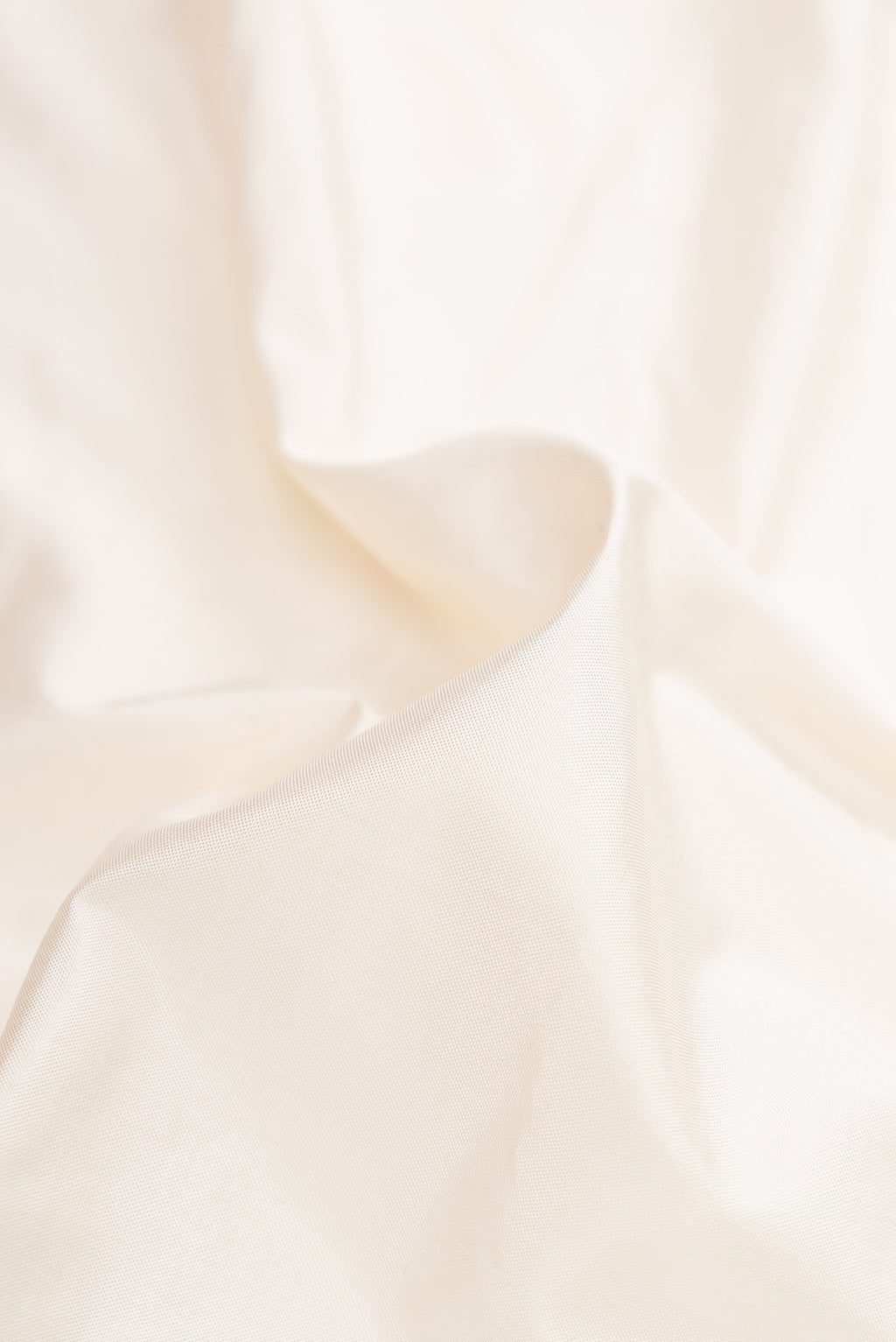 Close up of Off White Double Ikat Saree with Plain Body and Ganga Jamuna Border.  displaying folds