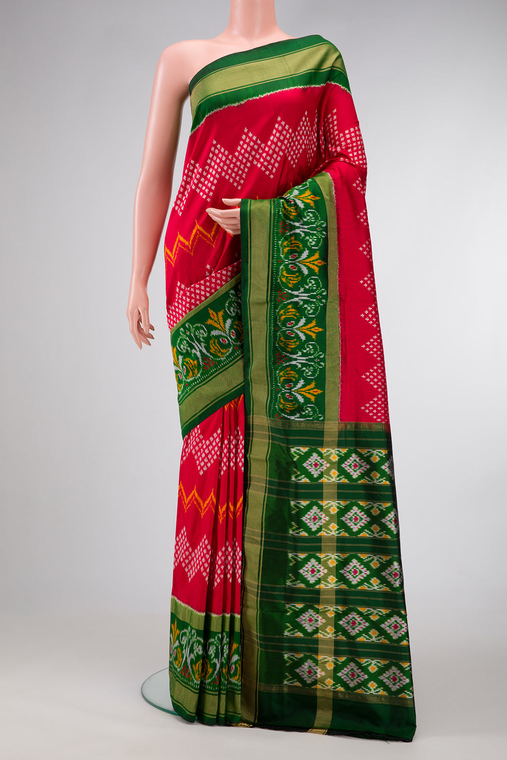 Red Dual Tone Double Ikat Saree with Ikat Print on the body and Ikat Border.  displayed on a mannequin