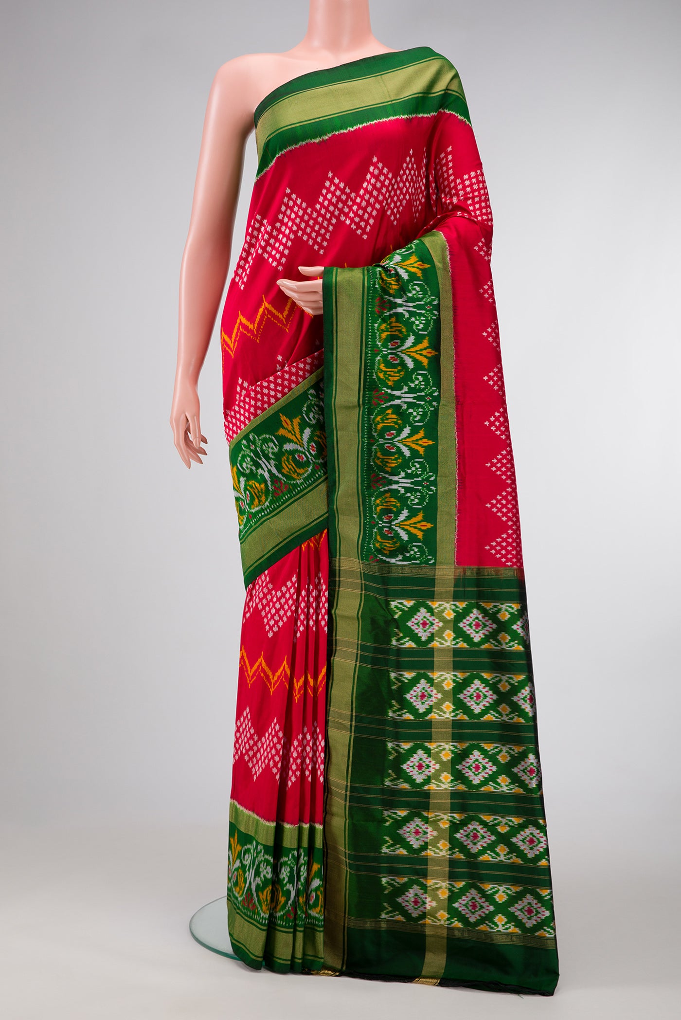 Red Dual Tone Double Ikat Saree with Ikat Print on the body and Ikat Border.  displayed on a mannequin