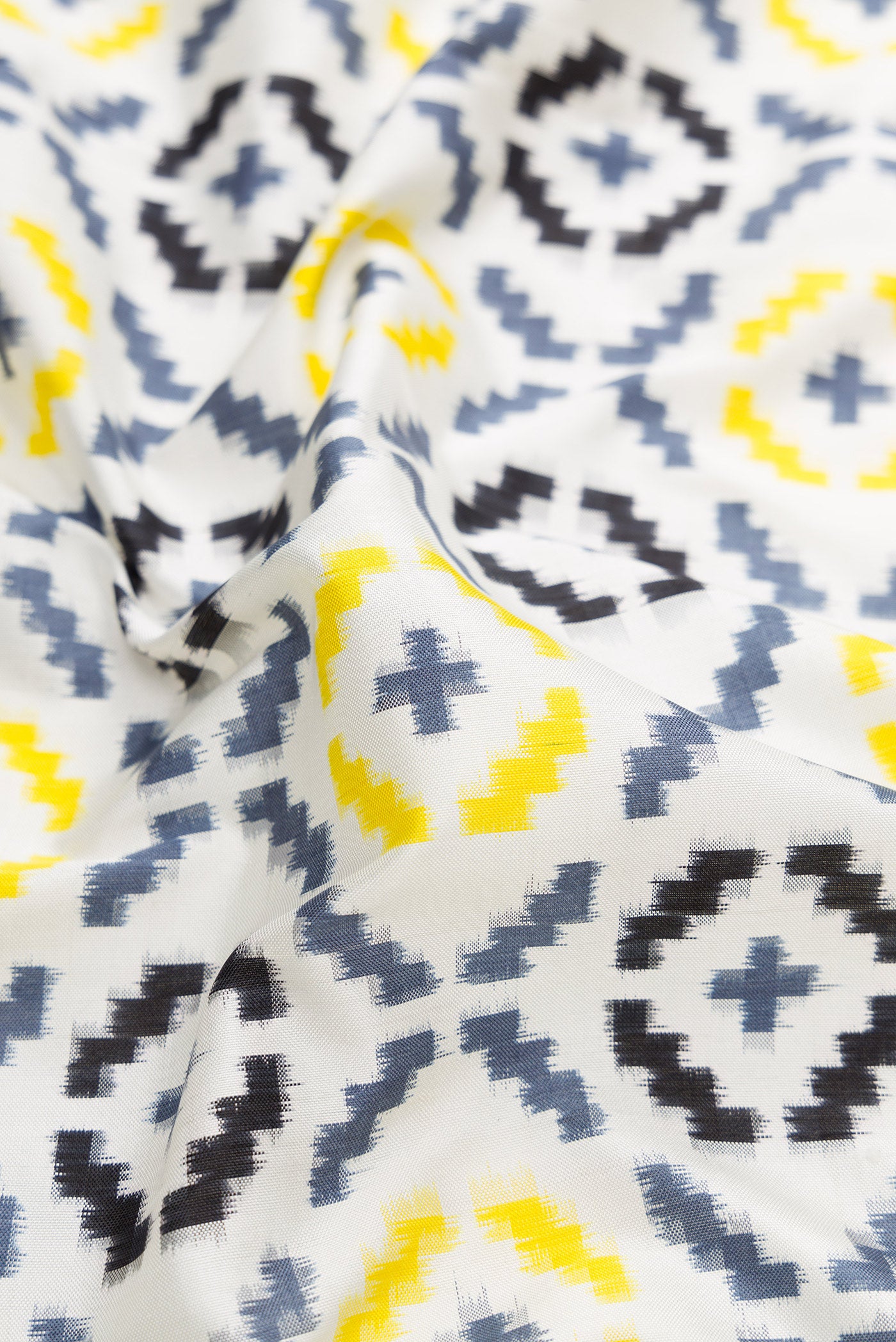 Close up of Off White Dual Tone Double Ikat Saree with Ikat Print on the body and Plain Border.  displaying folds