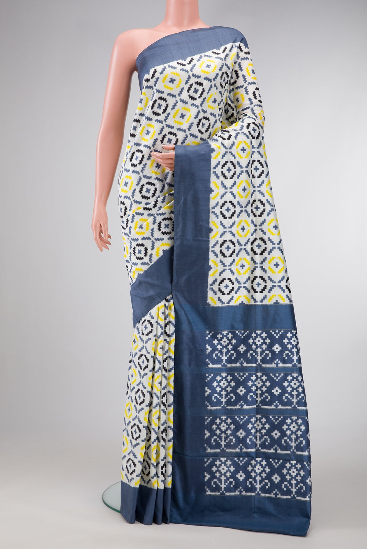 Off White Dual Tone Double Ikat Saree with Ikat Print on the body and Plain Border.  displayed on a mannequin