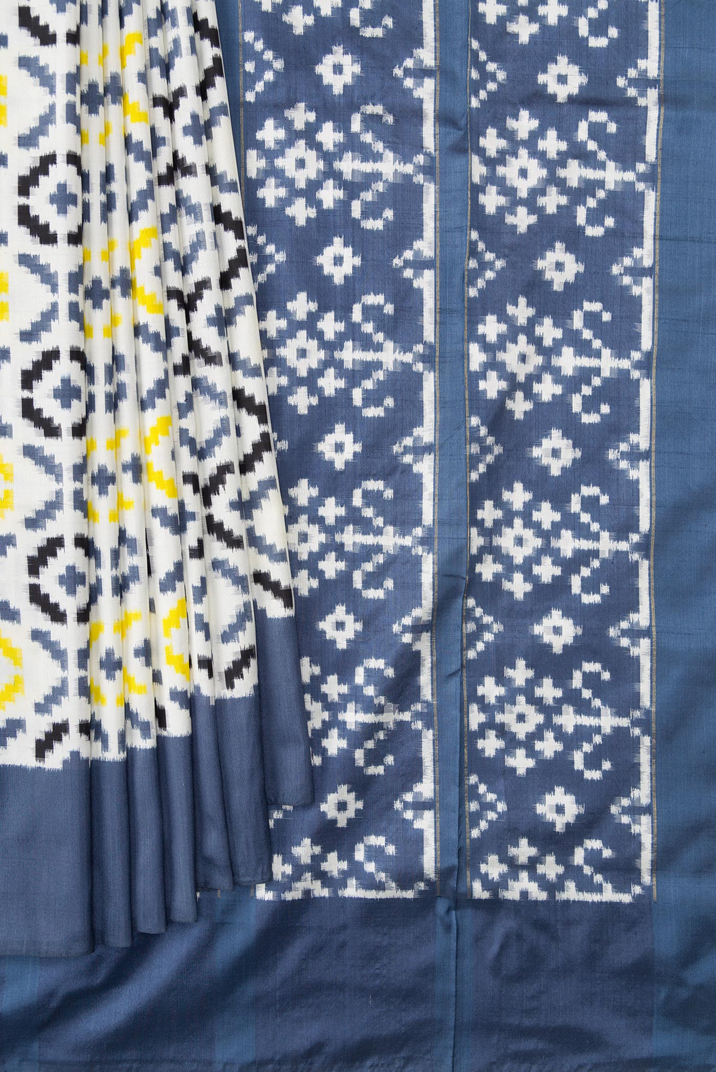 Pleats and pallu of Off White Dual Tone Double Ikat Saree with Ikat Print on the body and Plain Border. 