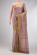 Brown Dual Tone Double Ikat Saree with Ikat Print on the body and Zari Border.  displayed on a mannequin