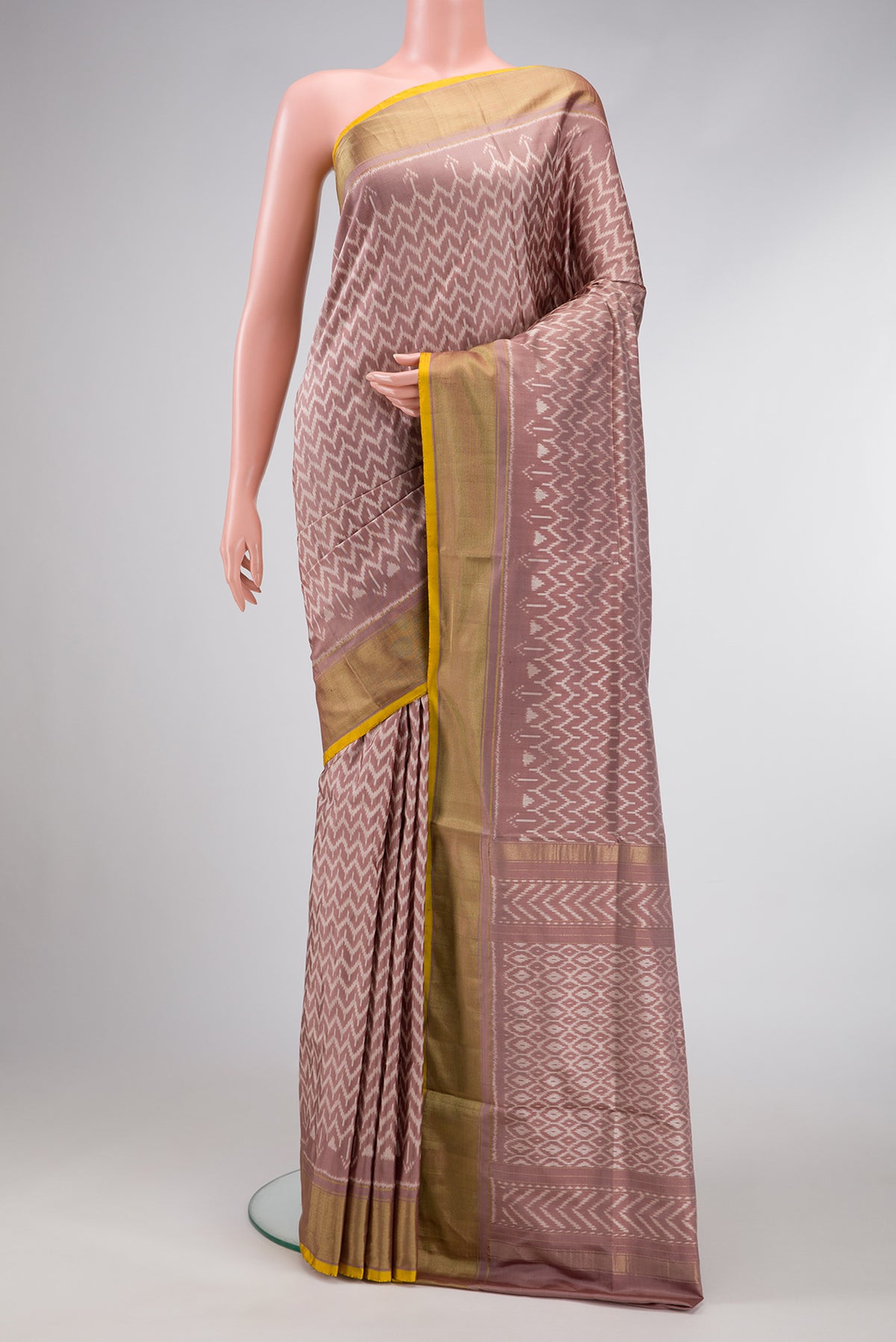 Brown Dual Tone Double Ikat Saree with Ikat Print on the body and Zari Border.  displayed on a mannequin