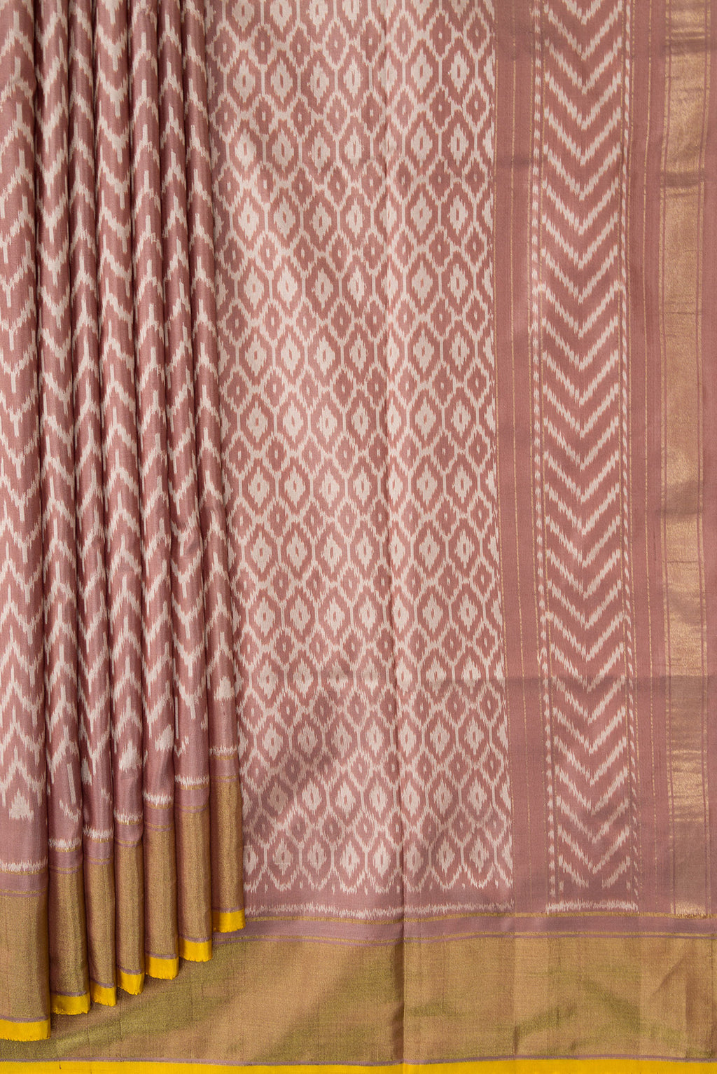 Pleats and pallu of Brown Dual Tone Double Ikat Saree with Ikat Print on the body and Zari Border. 