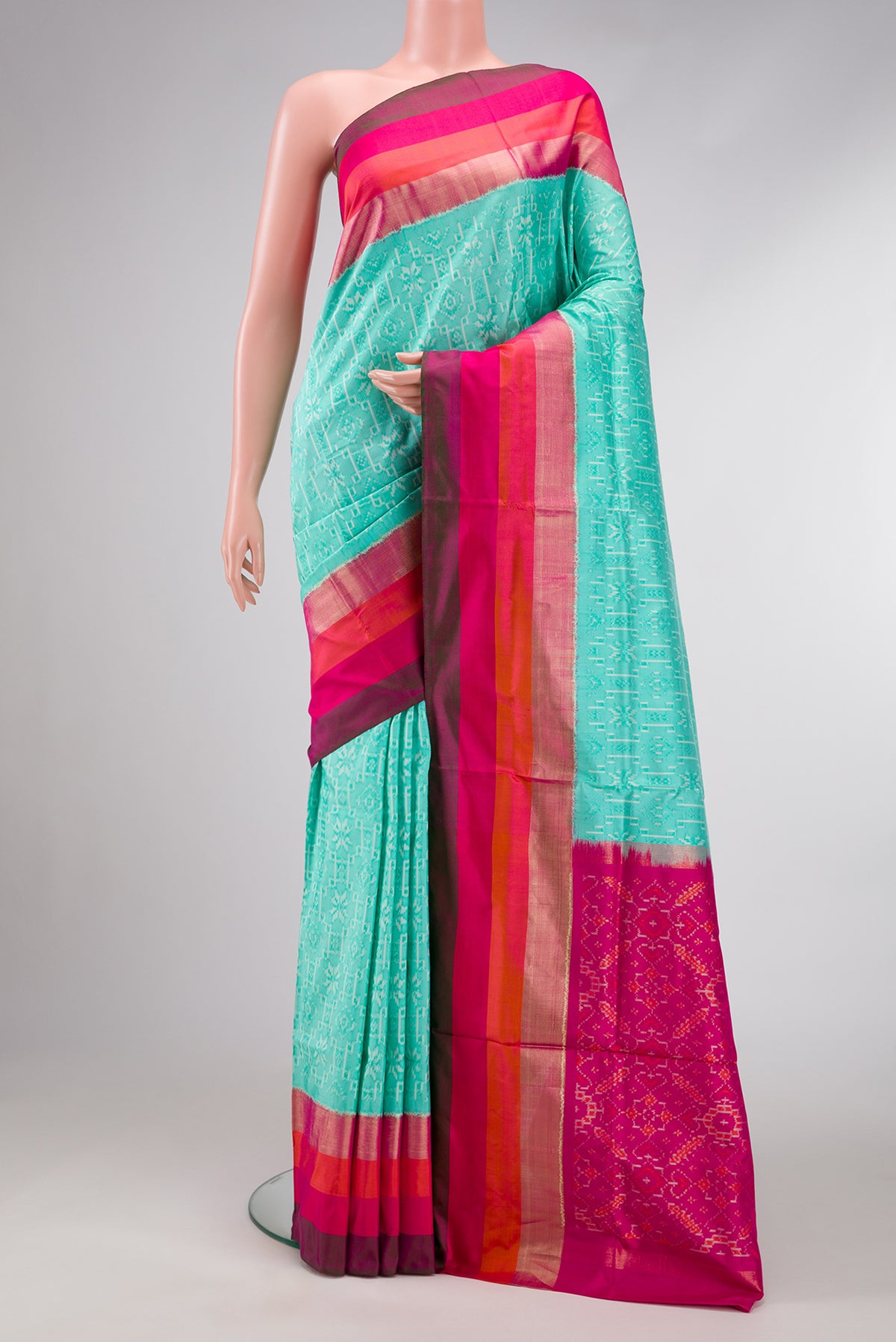 Sea Green Dual Tone Double Ikat Saree with Ikat Print on the body and Zari Border.  displayed on a mannequin