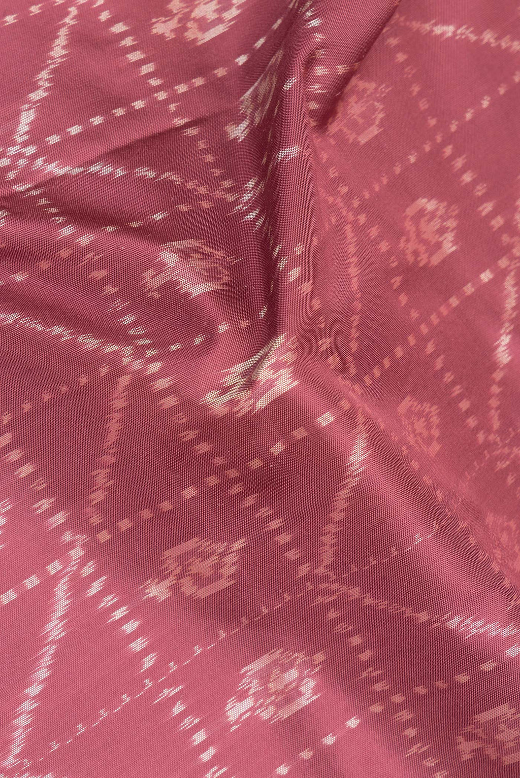 Close up of Pure Silk Mauve Pochampally Saree with Ikat design on the body and Plain Border.  displaying folds