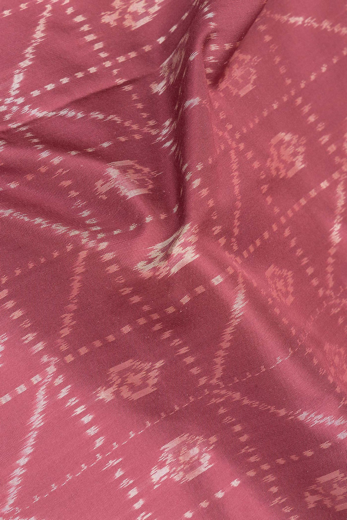 Close up of Pure Silk Mauve Pochampally Saree with Ikat design on the body and Plain Border.  displaying folds