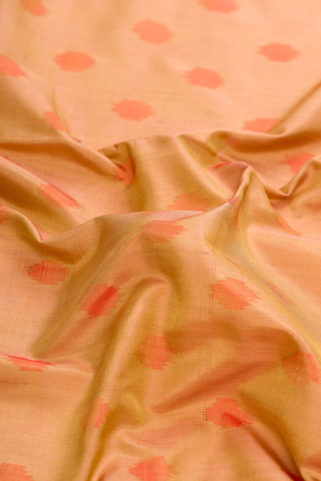 Close up of Gold Dual Tone Double Ikat Saree with Ikat Print on the body and Zari Border.  displaying folds