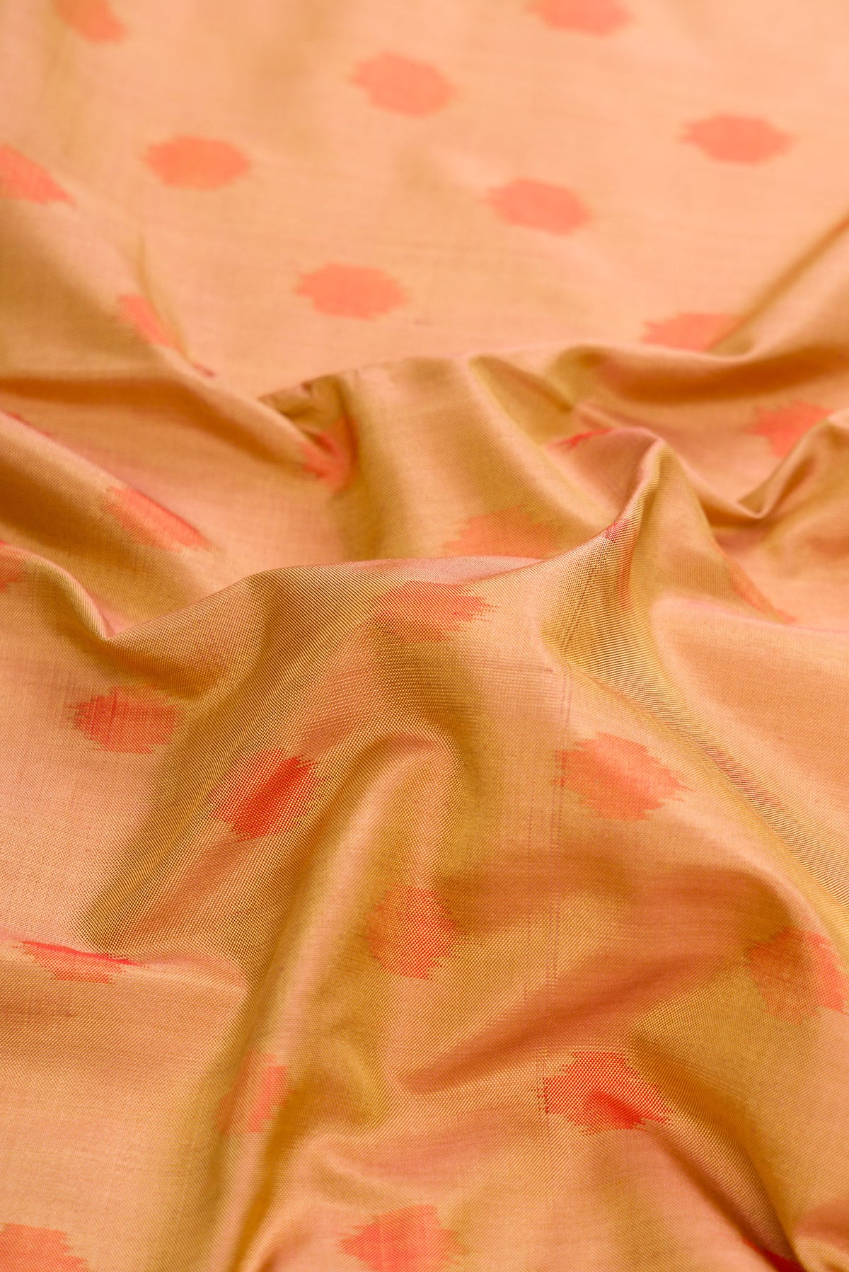 Close up of Gold Dual Tone Double Ikat Saree with Ikat Print on the body and Zari Border.  displaying folds