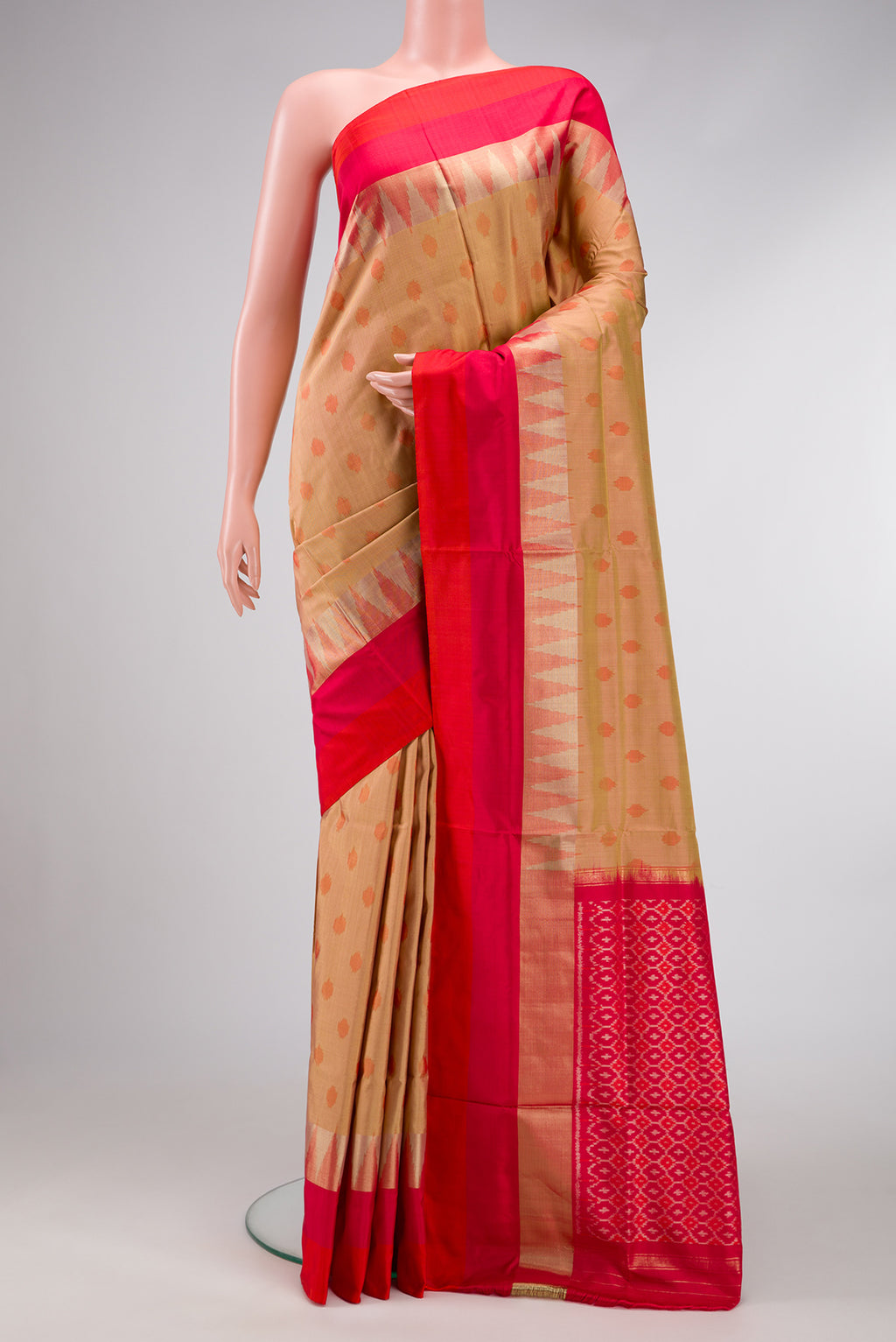 Gold Dual Tone Double Ikat Saree with Ikat Print on the body and Zari Border.  displayed on a mannequin