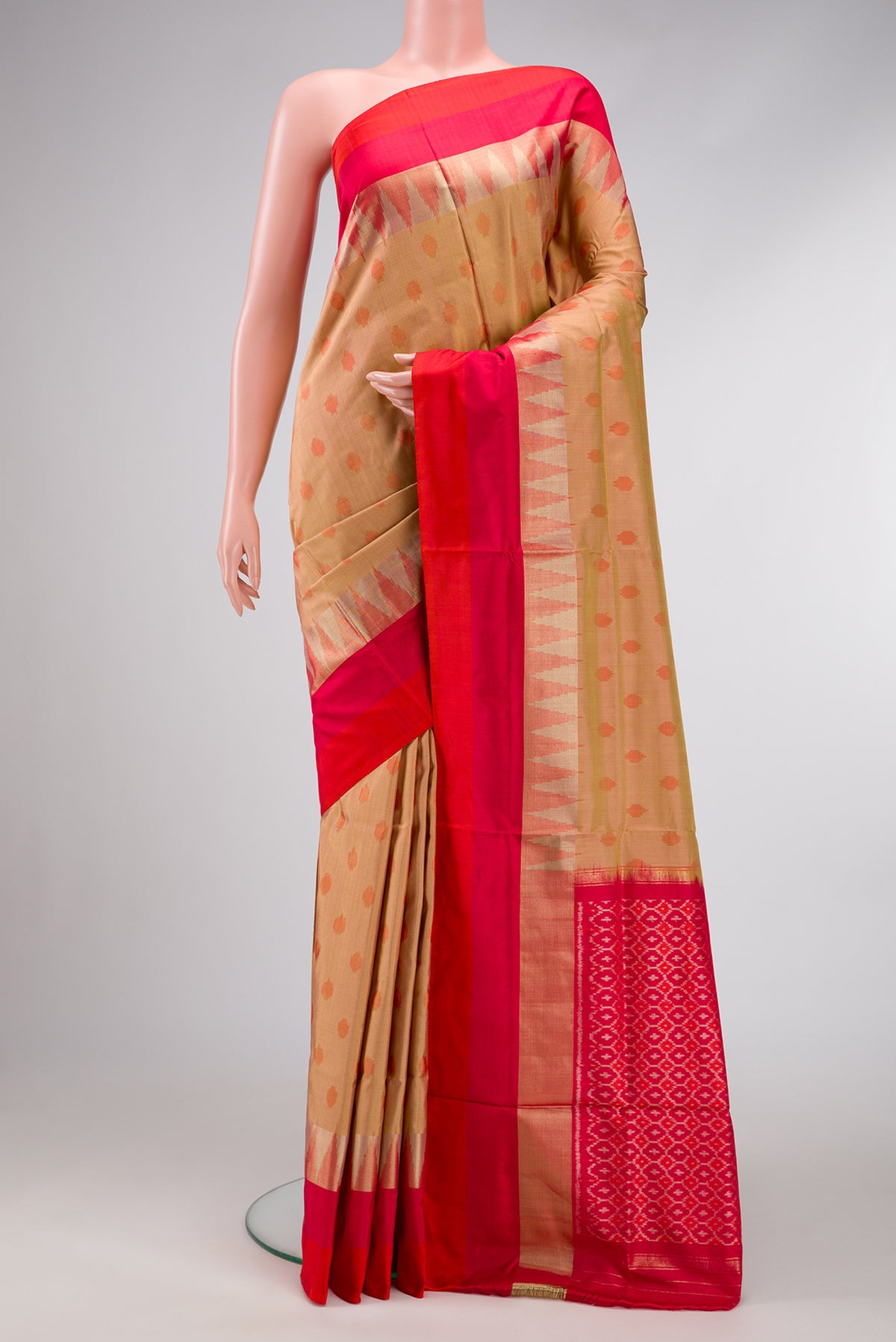 Gold Dual Tone Double Ikat Saree with Ikat Print on the body and Zari Border.  displayed on a mannequin