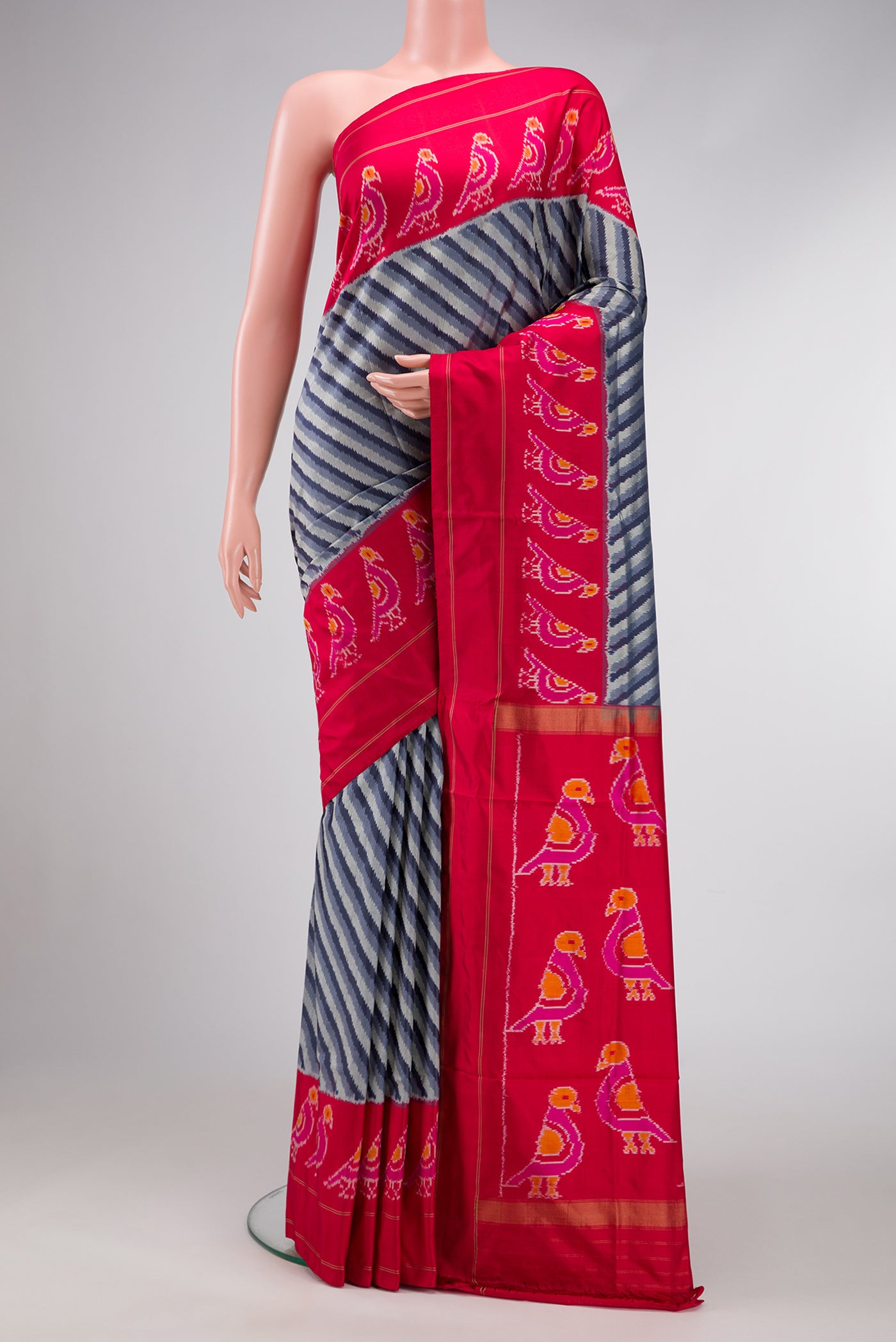 Grey Dual Tone Double Ikat Saree with Ikat Print on the body and Ikat Border.  displayed on a mannequin