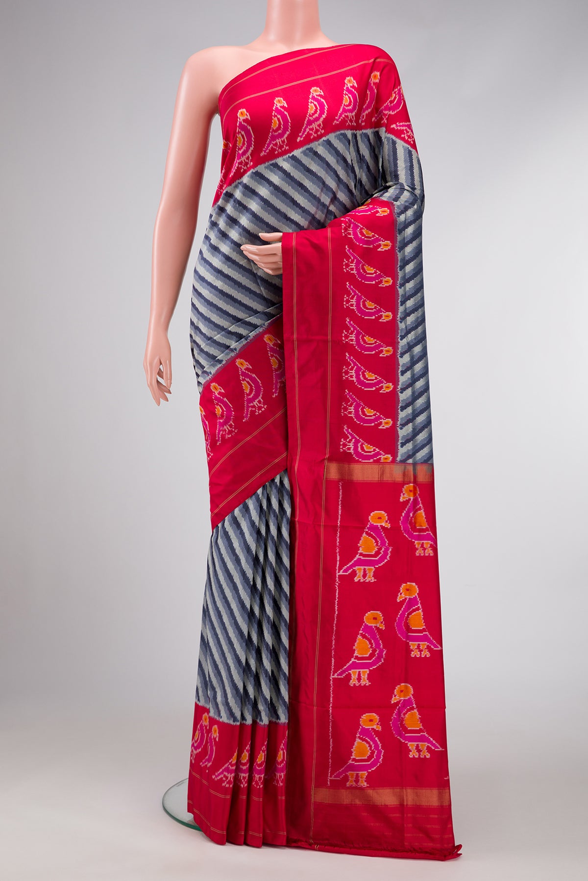 Grey Dual Tone Double Ikat Saree with Ikat Print on the body and Ikat Border.  displayed on a mannequin