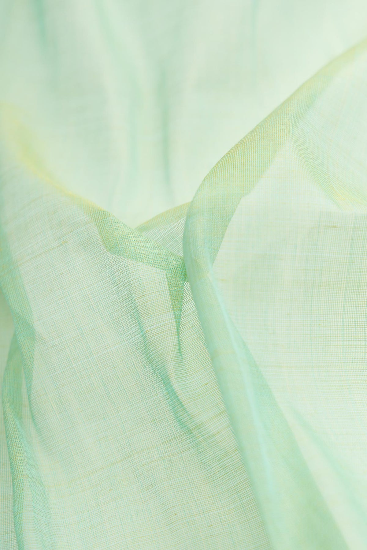 Close up of Pista Green Dual Tone Uppada Silk Saree with Plain Body and Thread Border.  displaying folds