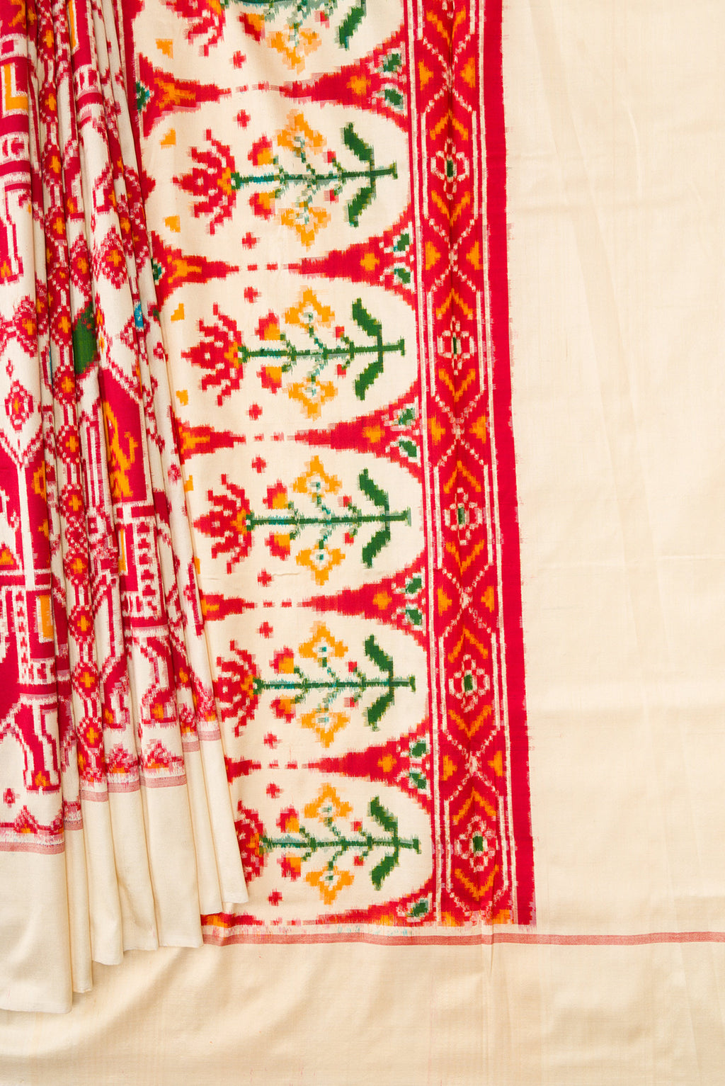 Pleats and pallu of Sandal Dual Tone Double Ikat Saree with Ikat Print on the body and Plain Border. 