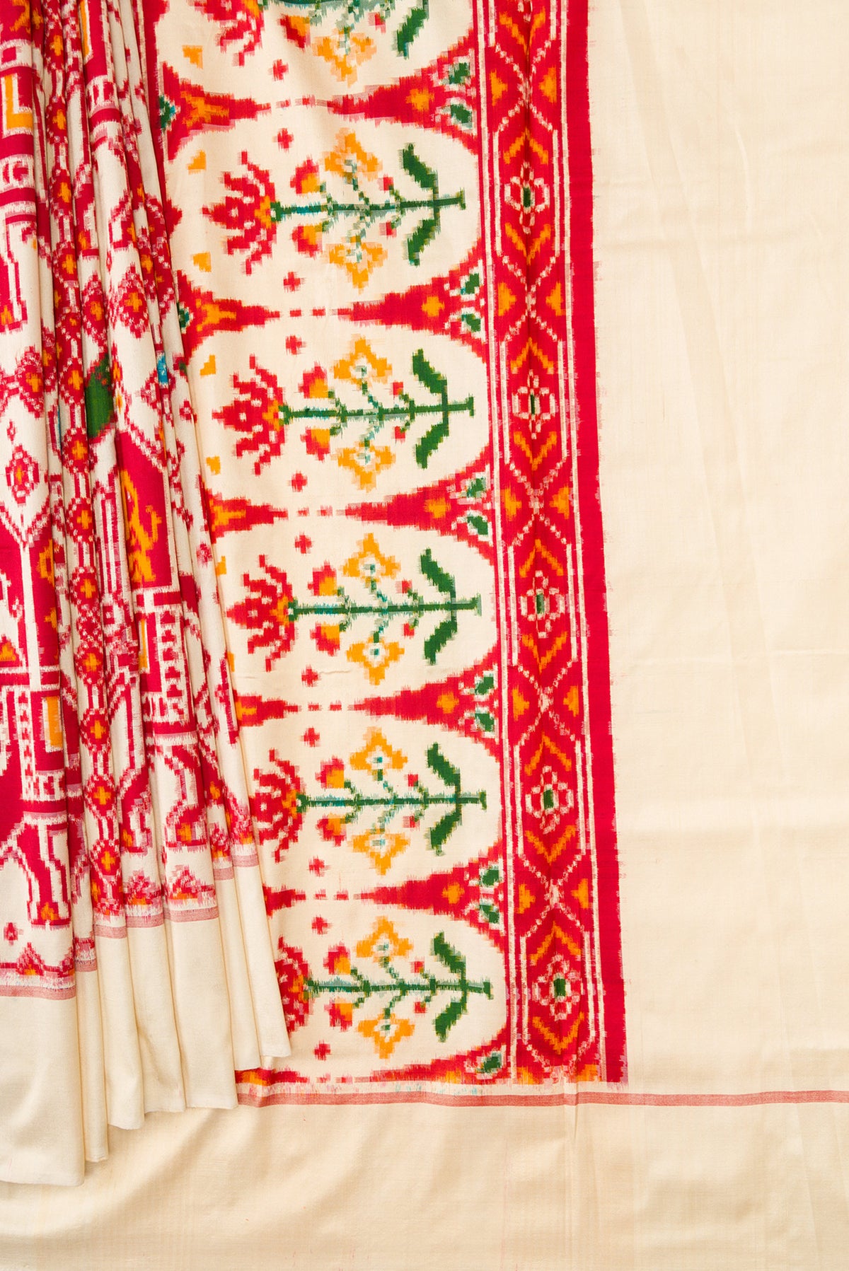 Pleats and pallu of Sandal Dual Tone Double Ikat Saree with Ikat Print on the body and Plain Border. 