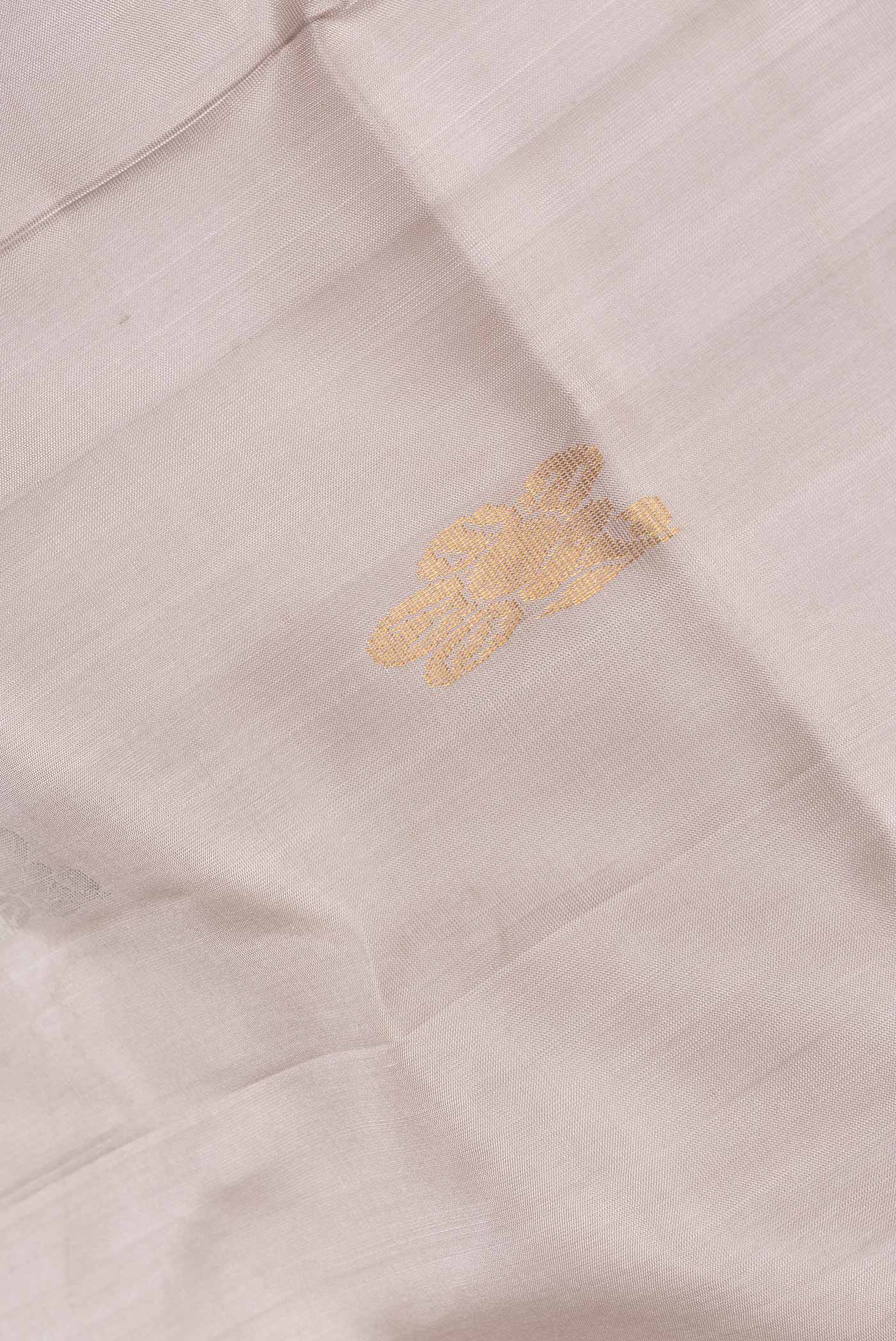 Close up of Grey Dual Tone Uppada Silk Saree with Zari Butta on the body and Zari Border.  displaying folds