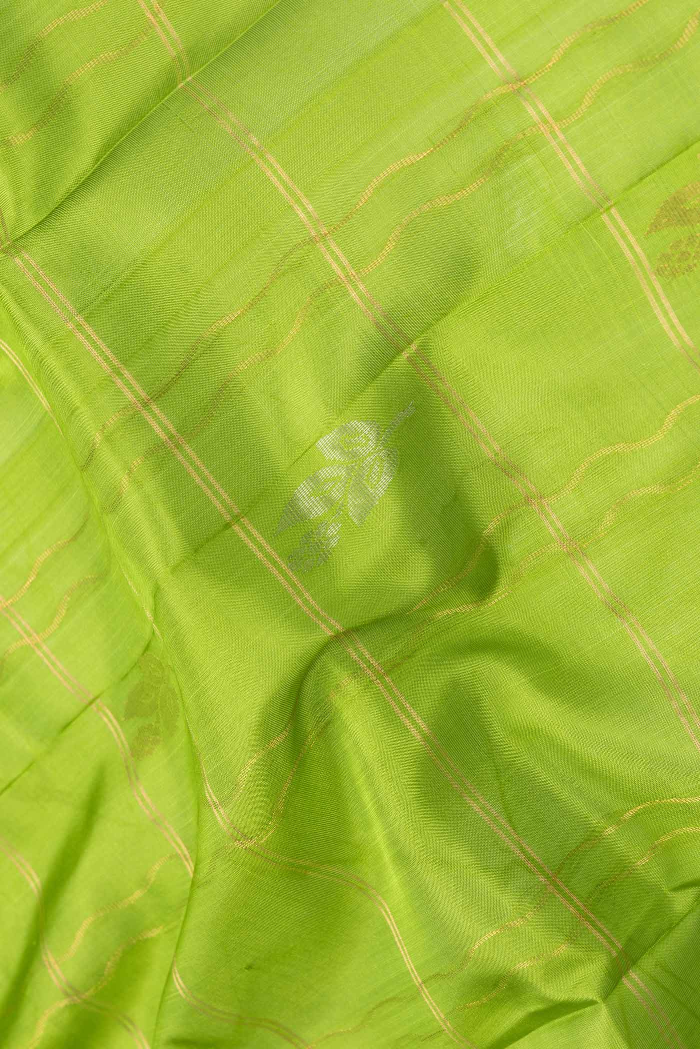 Close up of Parrot Green Dual Tone Uppada Silk Saree with Checked design on the body and Zari Border.  displaying folds