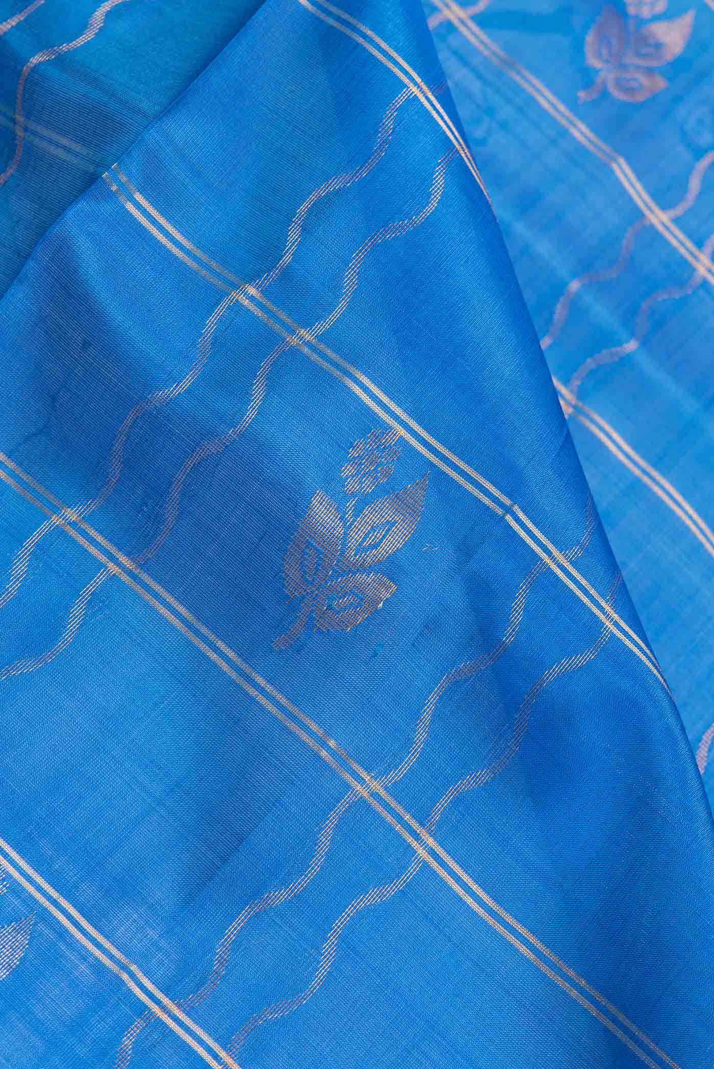 Close up of Royal Blue Dual Tone Uppada Silk Saree with Checked design on the body and Zari Border.  displaying folds