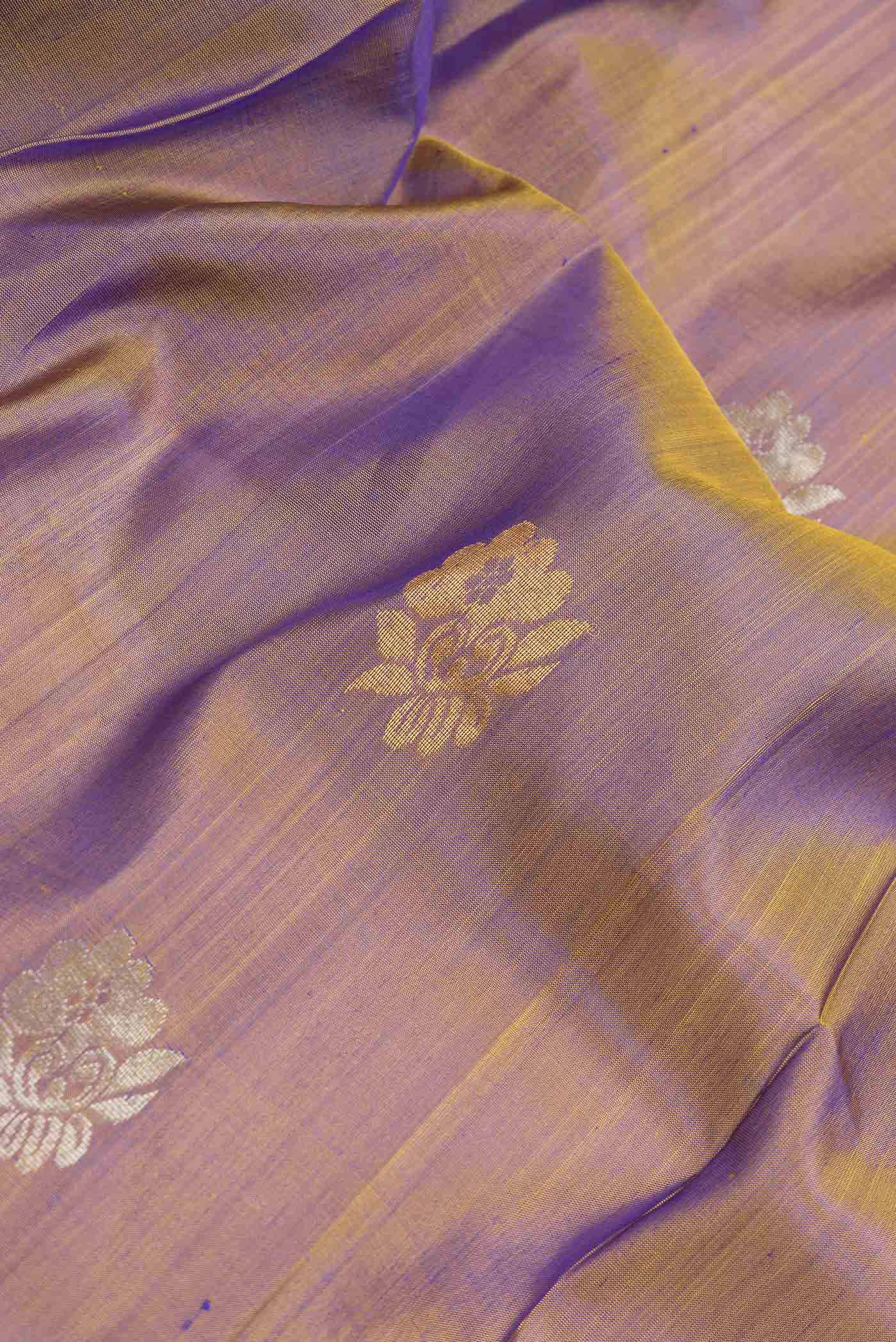 Close up of Brown Dual Tone Uppada Silk Saree with Zari Butta on the body and Zari Border.  displaying folds