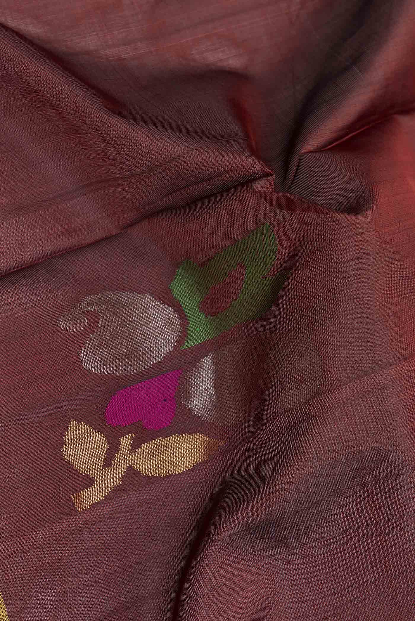 Close up of Coffee Brown Dual Tone Uppada Silk Saree with Zari Butta on the body and Fancy Border.  displaying folds
