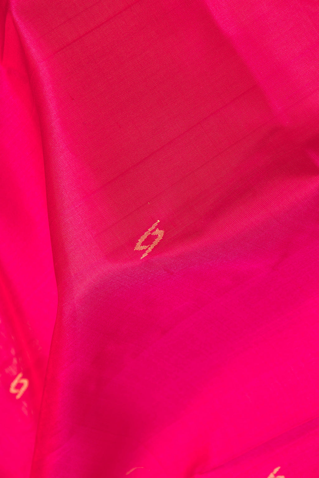 Close up of Pink Dual Tone Uppada Silk Saree with Zari Butta on the body and Zari Border.  displaying folds
