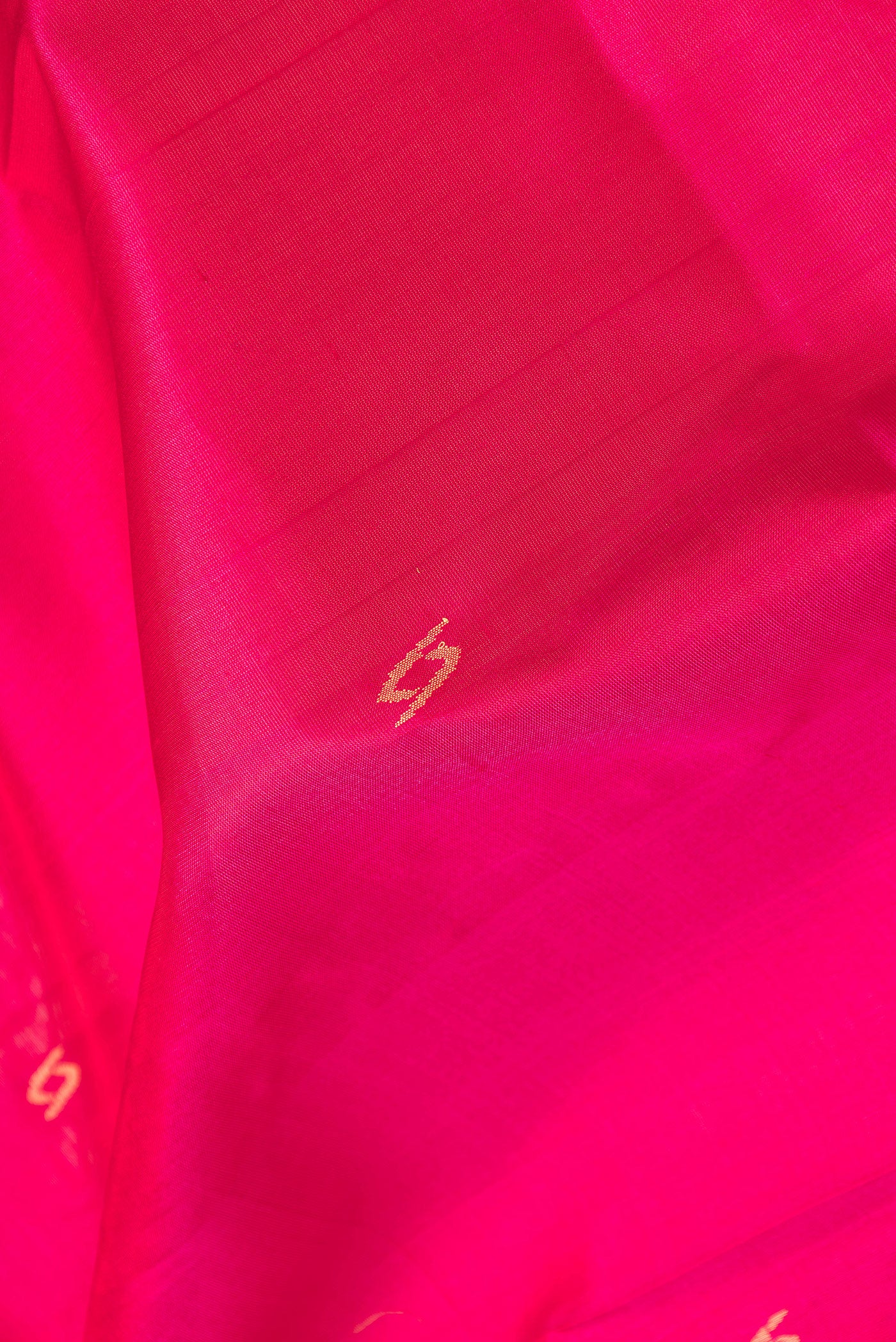 Close up of Pink Dual Tone Uppada Silk Saree with Zari Butta on the body and Zari Border.  displaying folds