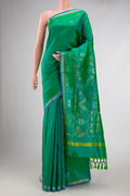 Green Dual Tone Uppada Silk Saree with Zari Butta on the body and Zari Border.  displayed on a mannequin