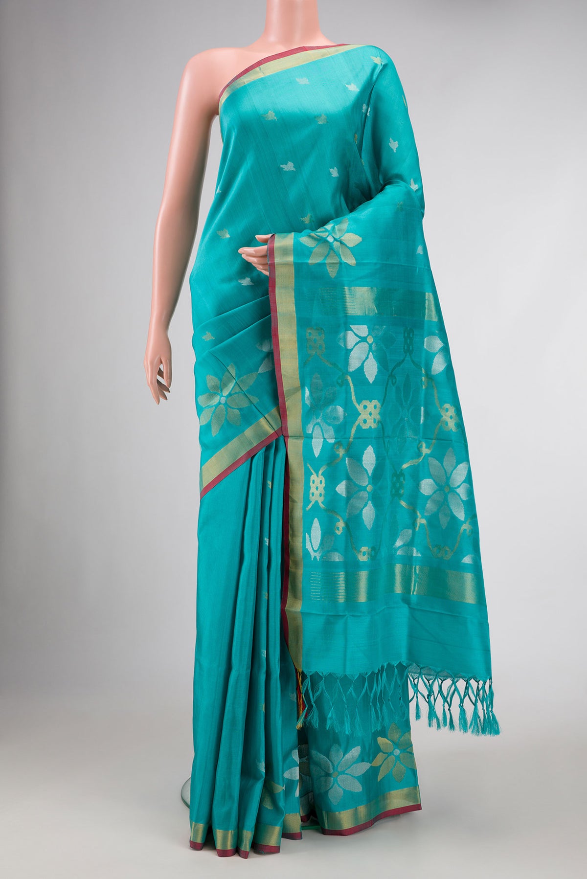 Sky Blue Dual Tone Uppada Silk Saree with Zari Butta on the body and Zari Border.  displayed on a mannequin