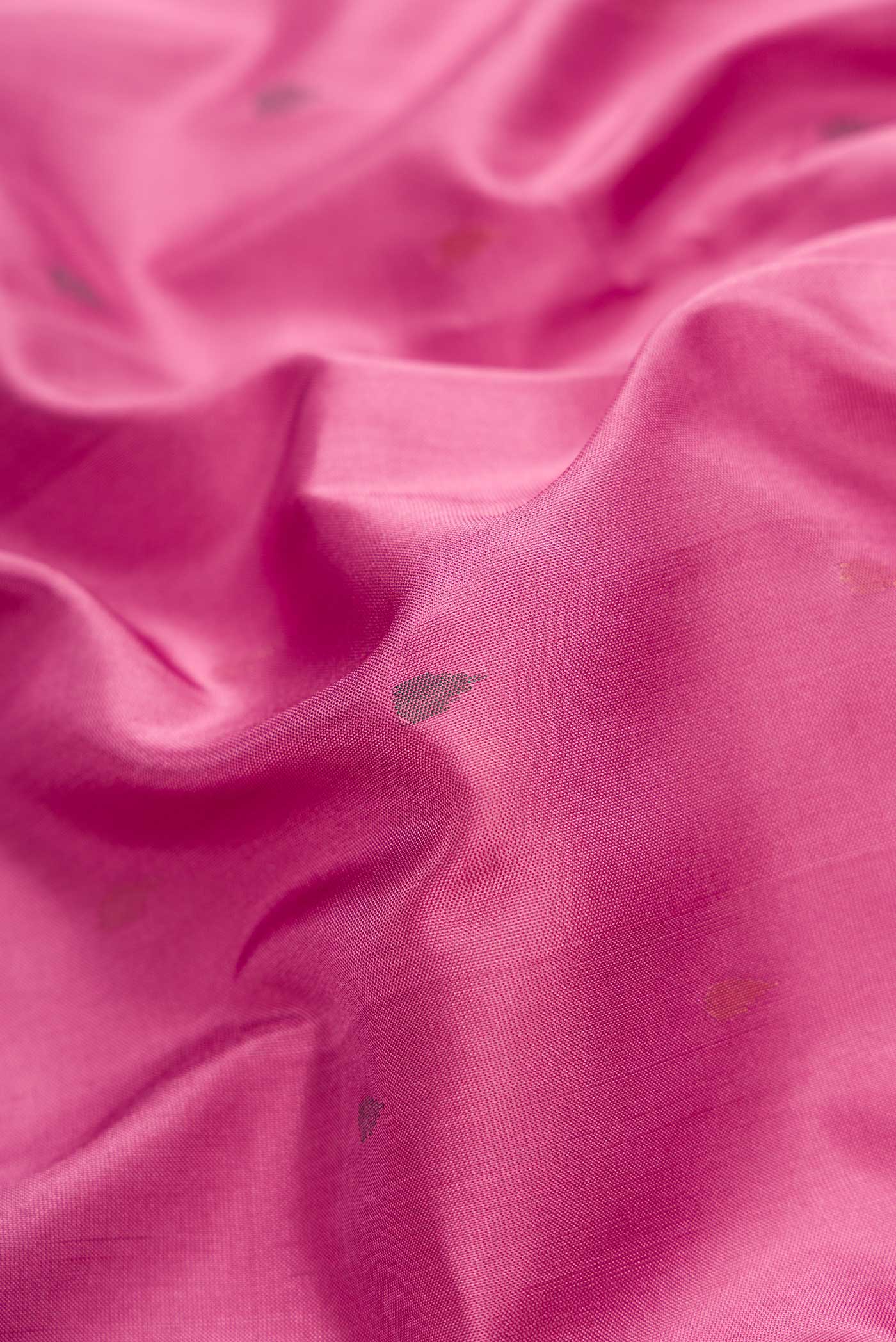 Close up of Pink Dual Tone Uppada Silk Saree with Zari And Thread Butta on the body and Zari Border.  displaying folds