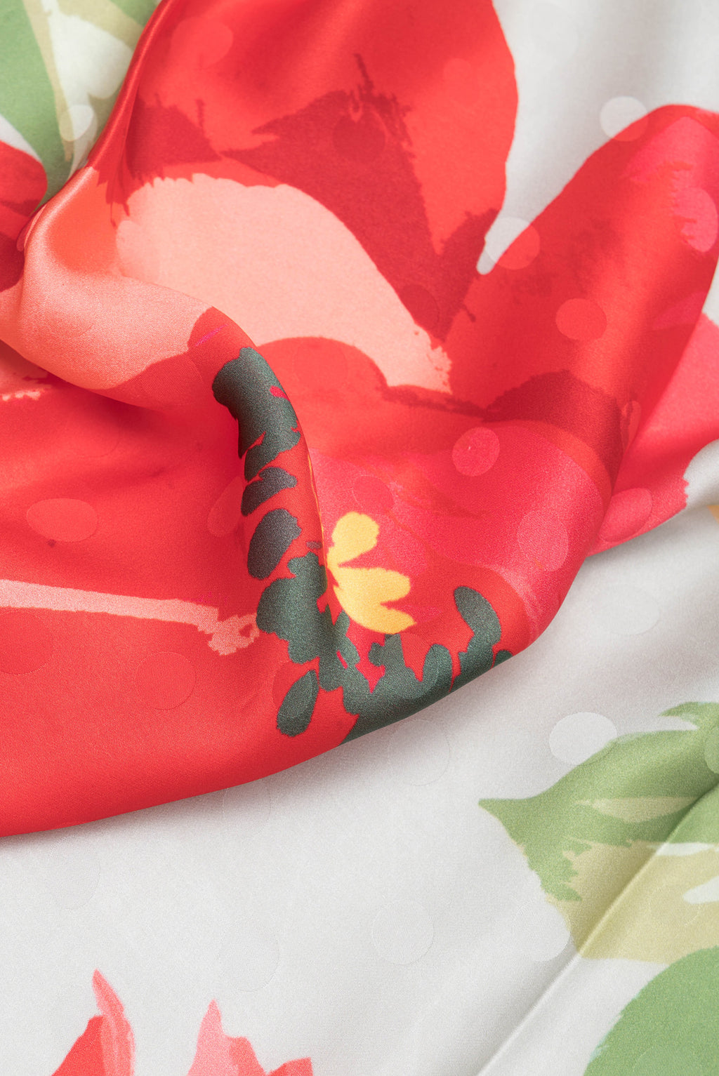 Close up of Grey Crepe Saree with Printed design on the body and Without Border.  displaying folds