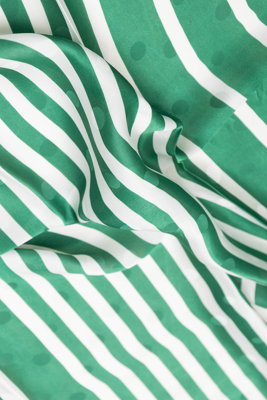 Close up of Green Dual Tone Mysore Crepe Saree with Printed design on the body and Without Border.  displaying folds