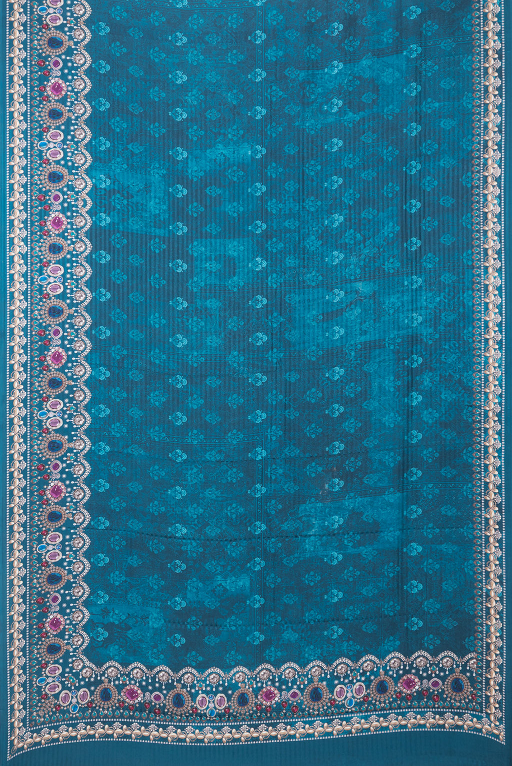 Flat view of Peacock Blue Crepe Saree with Printed design on the body and Printed Border. 
