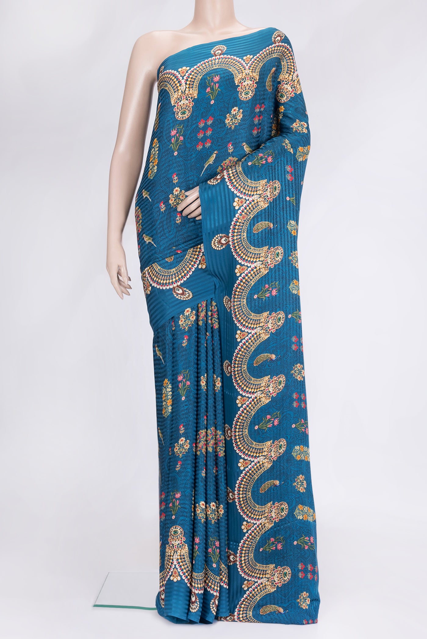 Peacock Blue Dual Tone Mysore Crepe Saree with Printed design on the body and Printed Border.  displayed on a mannequin
