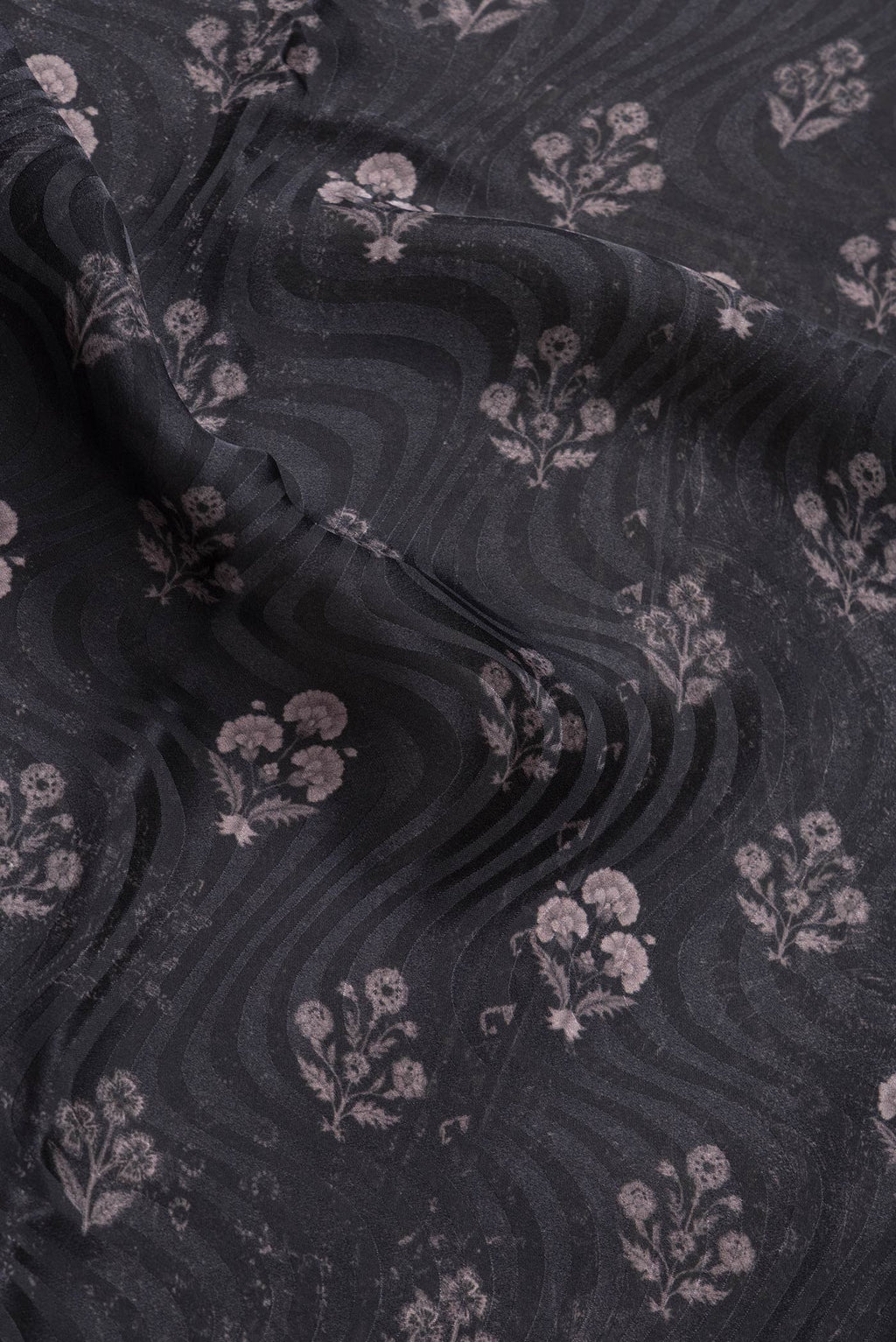 Close up of Black Dual Tone Mysore Crepe Saree with Printed design on the body and Printed Border.  displaying folds