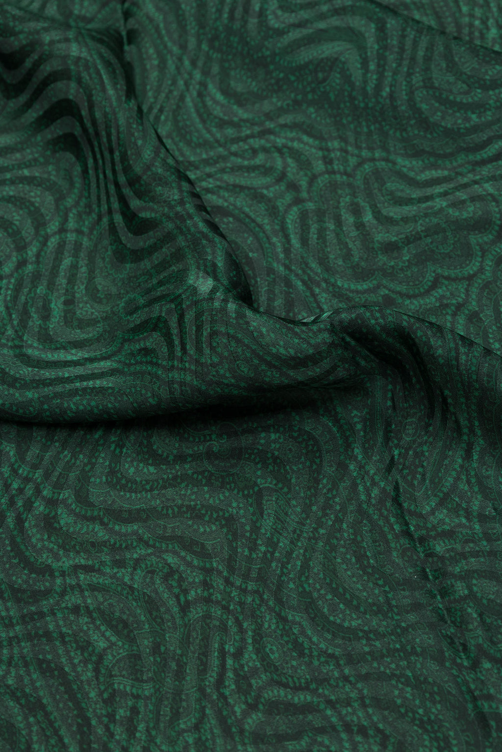 Close up of Bottle Green Dual Tone Mysore Crepe Saree with Printed design on the body and Printed Border.  displaying folds