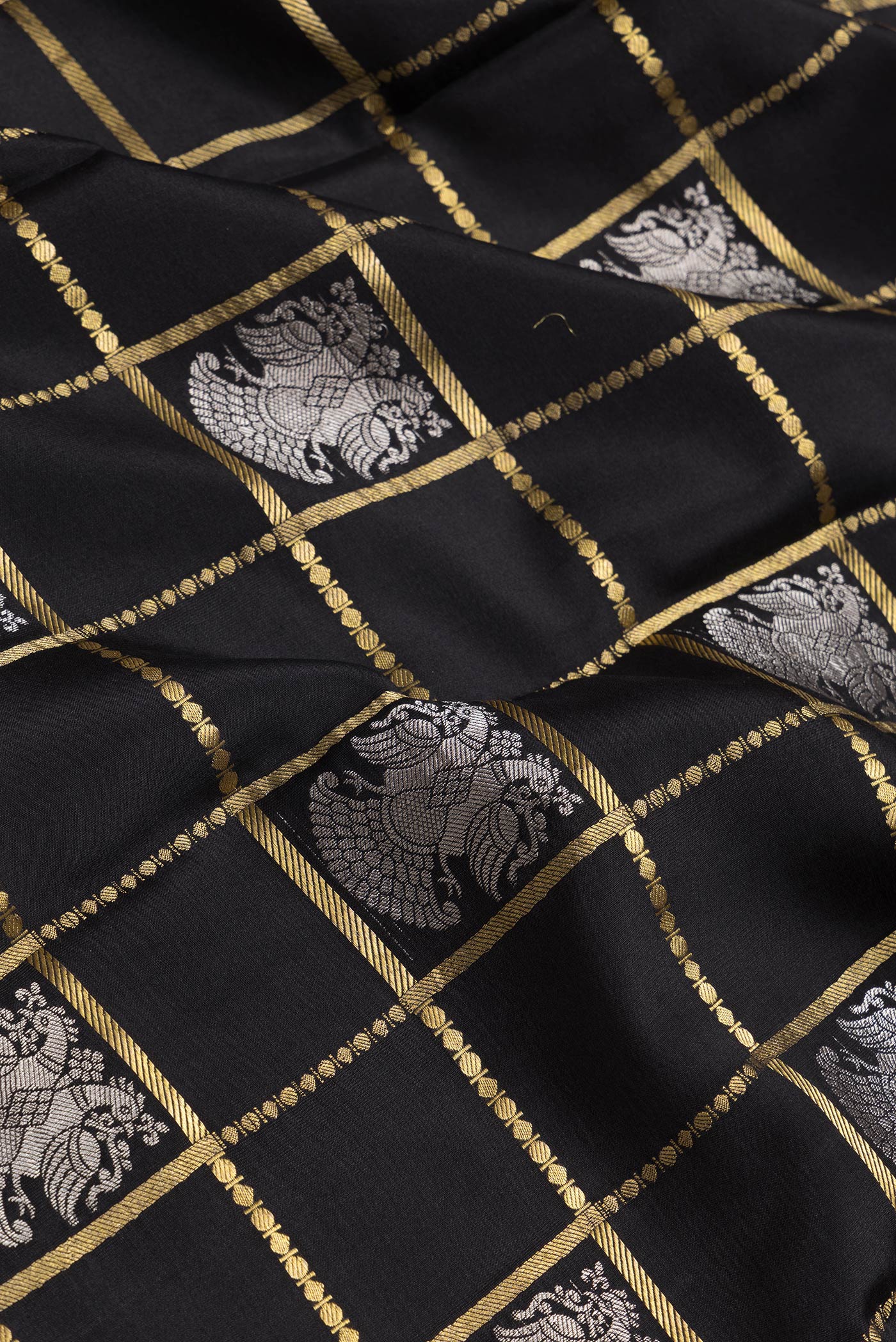 Close up of Black Dual Tone Mysore Silk Saree with Checked design on the body and Zari Border.  displaying folds