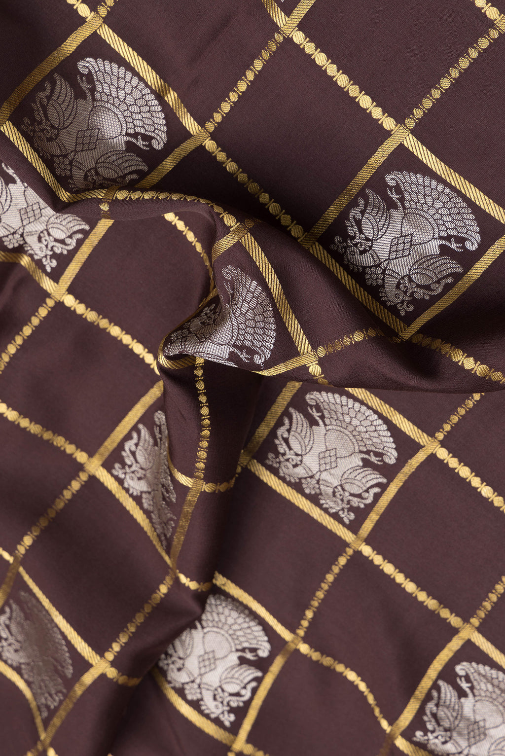 Close up of Brown Dual Tone Mysore Silk Saree with Checked design on the body and Zari Border.  displaying folds