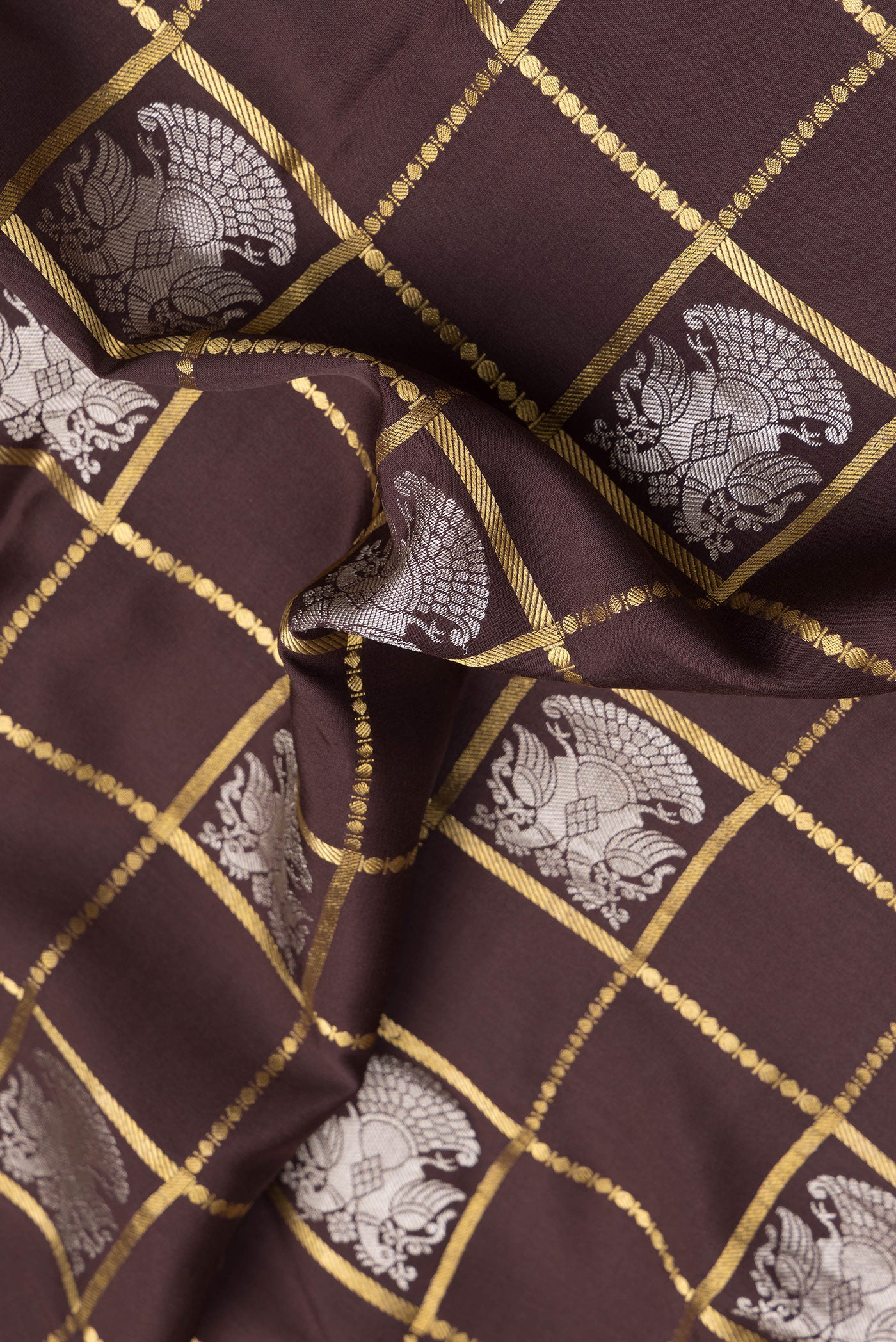Close up of Brown Dual Tone Mysore Silk Saree with Checked design on the body and Zari Border.  displaying folds
