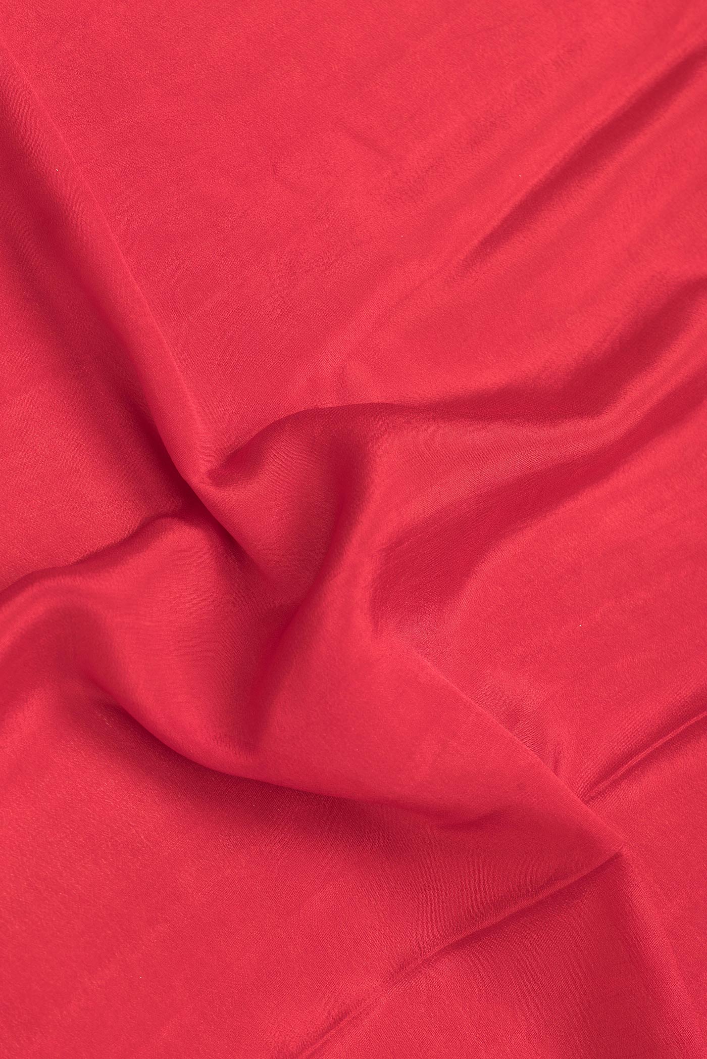 Close up of Red Dual Tone Mysore Georgette Saree with Plain Body and Zari Border.  displaying folds