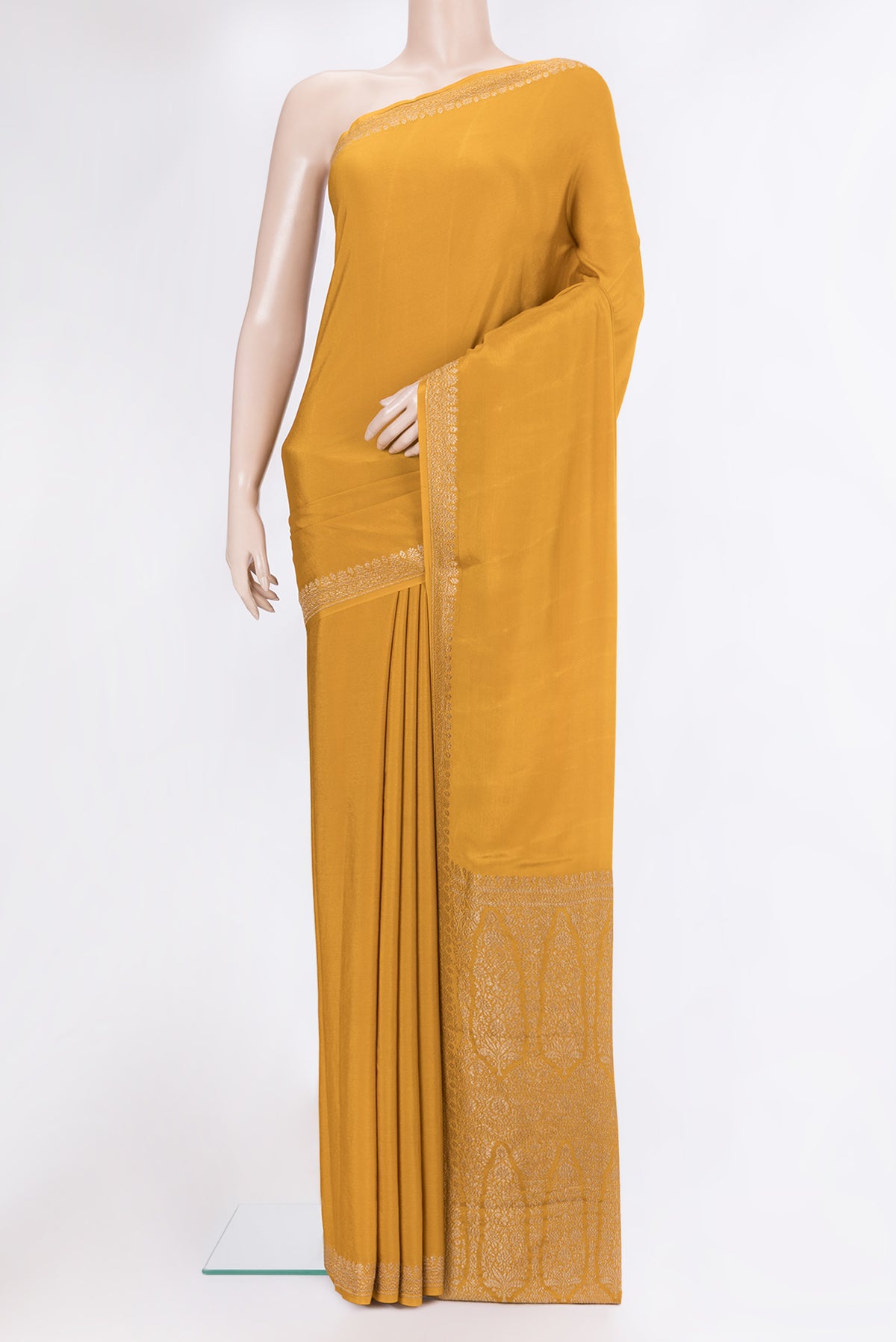 Mustard Crepe Saree with Plain Body and Zari Border.  displayed on a mannequin