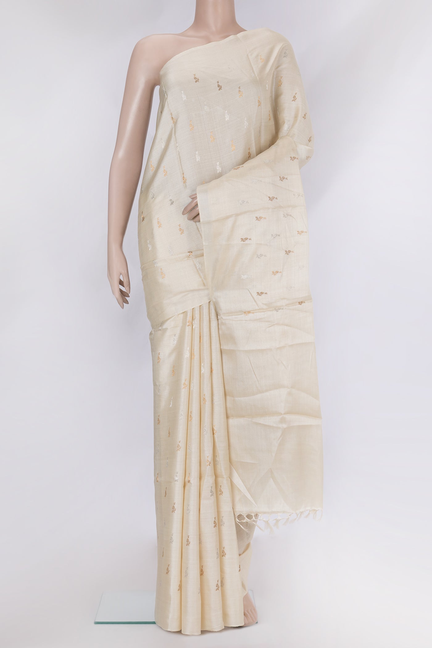 Off White Dual Tone Tussar Silk Saree with Zari Butta on the body and Without Border.  displayed on a mannequin
