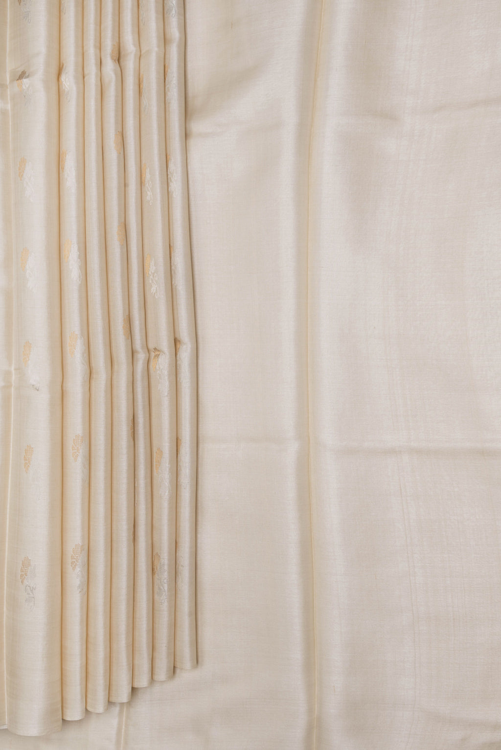 Pleats and pallu of Beige Dual Tone Tussar Silk Saree with Zari Butta on the body and Without Border. 