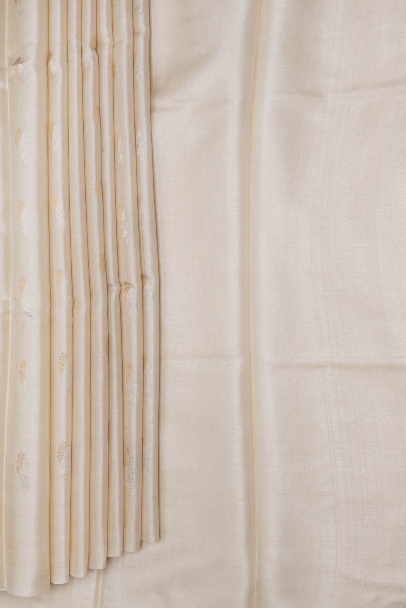 Pleats and pallu of Beige Dual Tone Tussar Silk Saree with Zari Butta on the body and Without Border. 