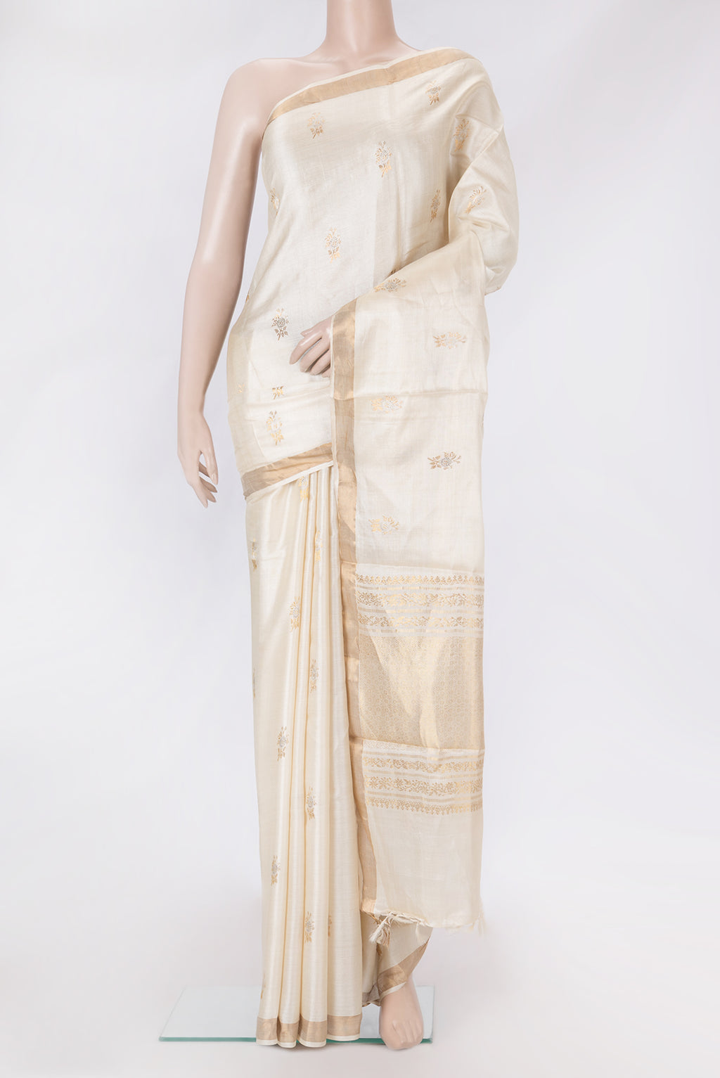 Beige Dual Tone Tussar Silk Saree with Zari Butta on the body and Zari Border.  displayed on a mannequin
