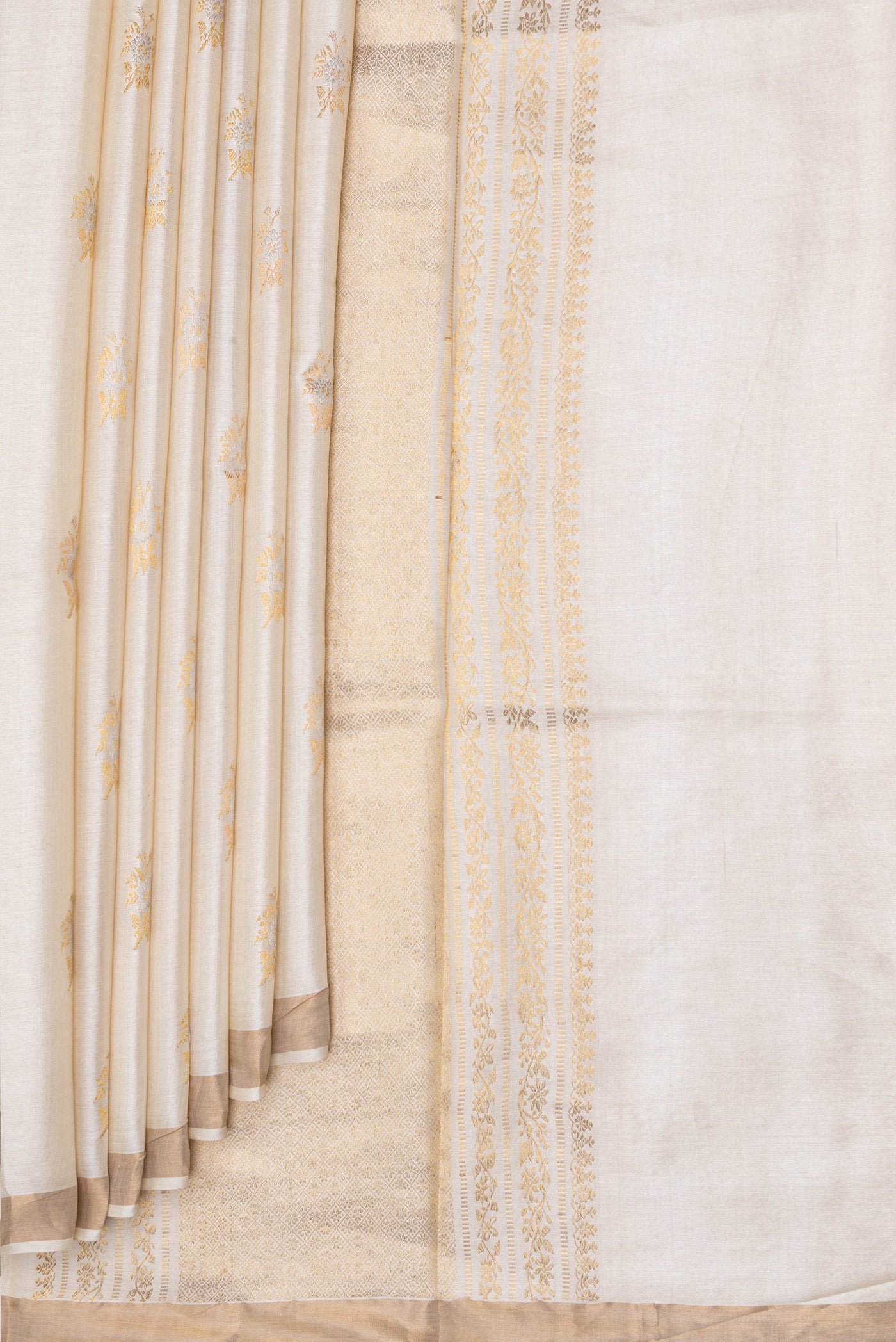 Pleats and pallu of Beige Dual Tone Tussar Silk Saree with Zari Butta on the body and Zari Border. 