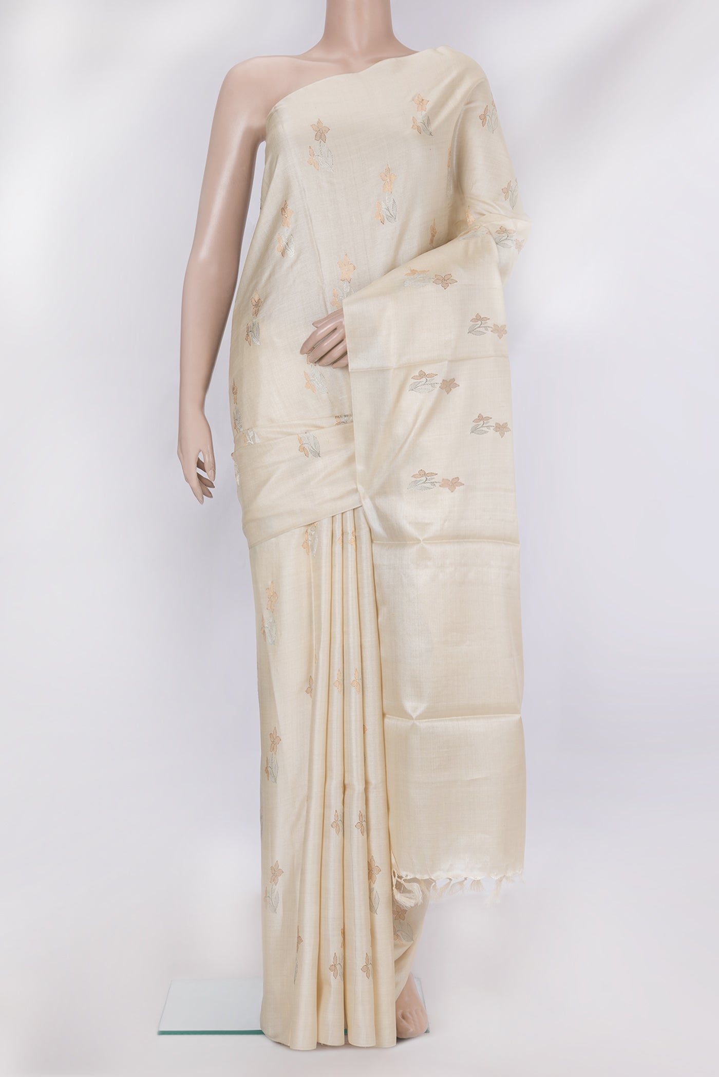 Off White Tussar Silk Saree with Zari Butta on the body and Without Border.  displayed on a mannequin