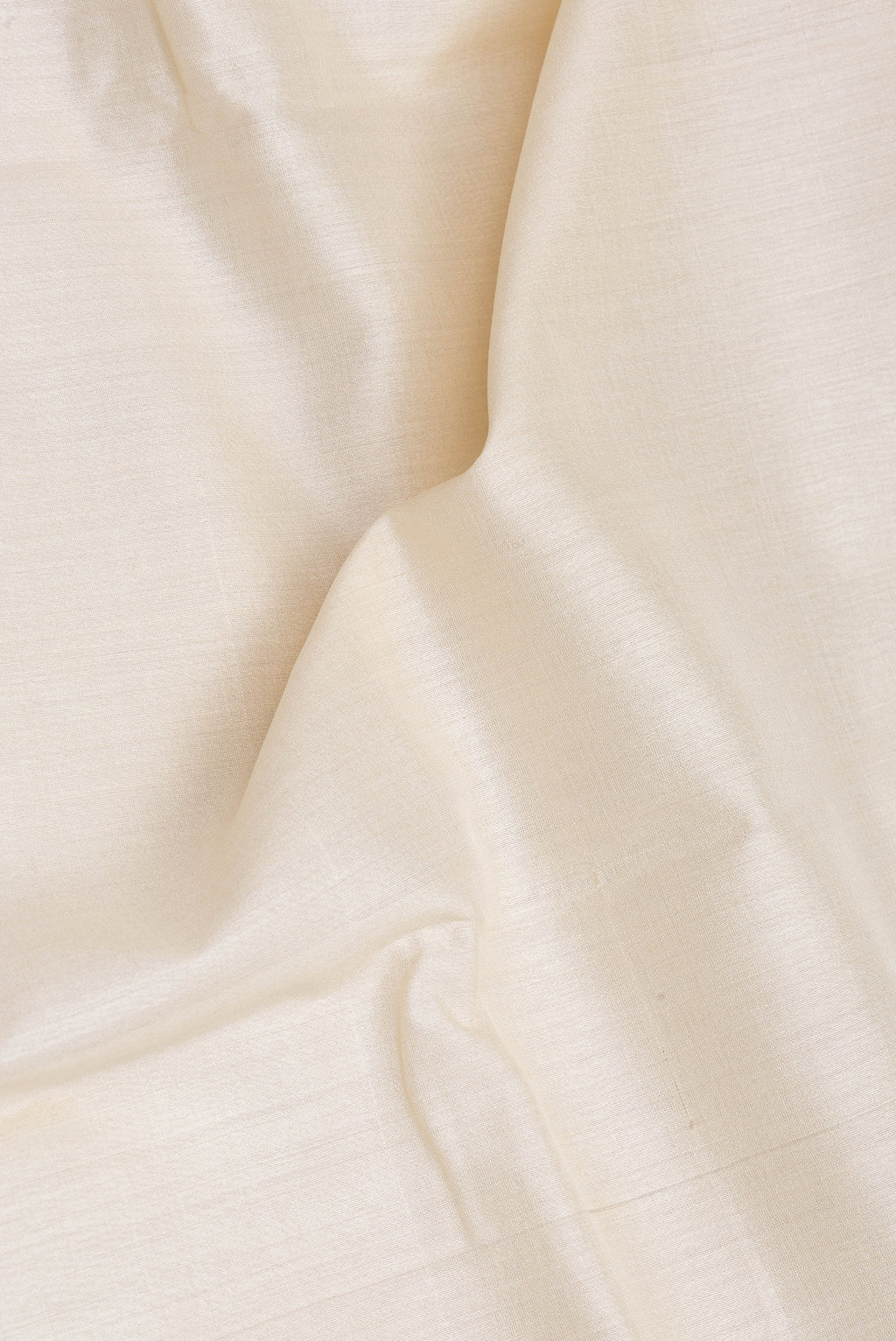 Close up of Beige Tussar Silk Saree with Checked design on the body and Zari Border.  displaying folds