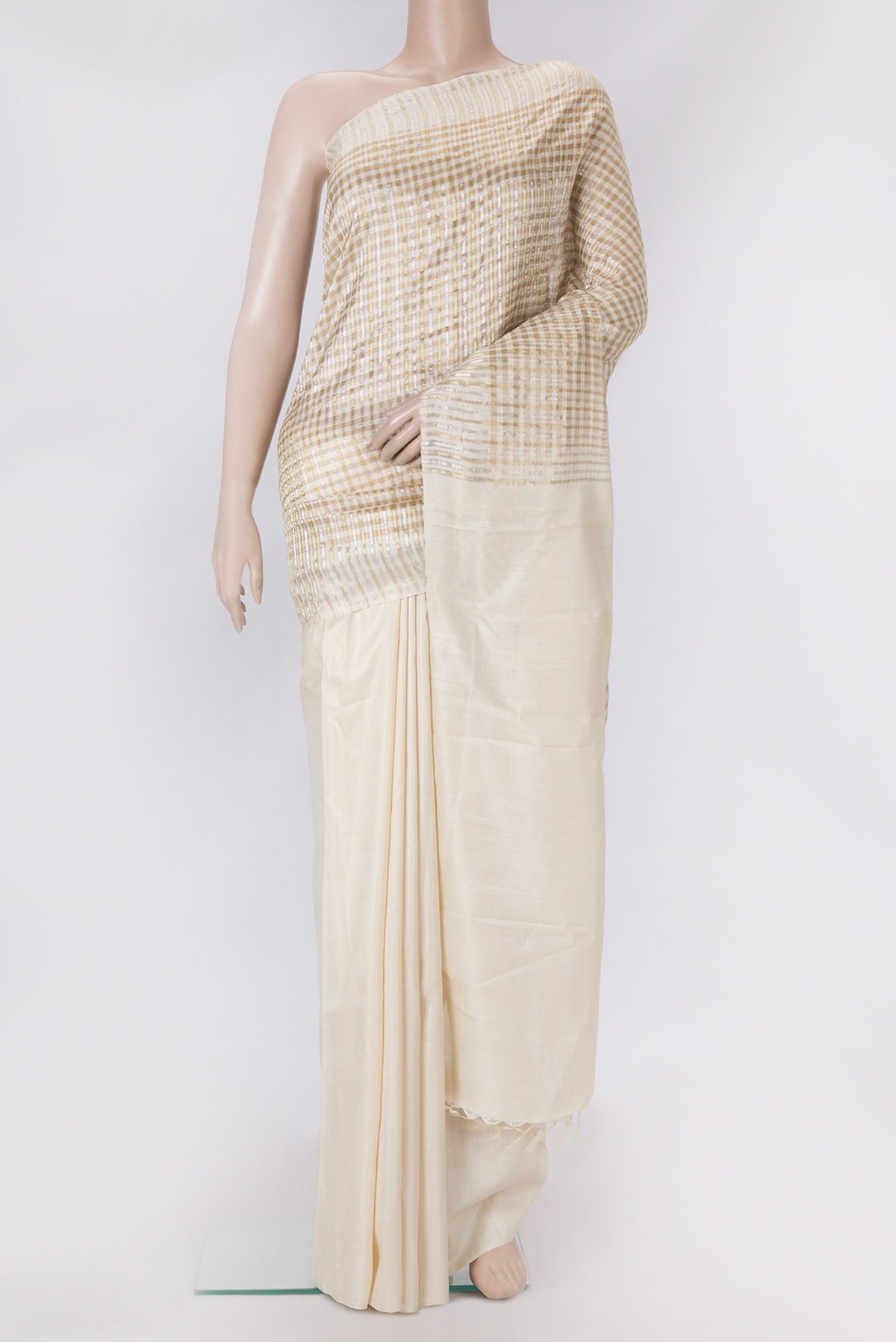 Beige Tussar Silk Saree with Checked design on the body and Zari Border.  displayed on a mannequin